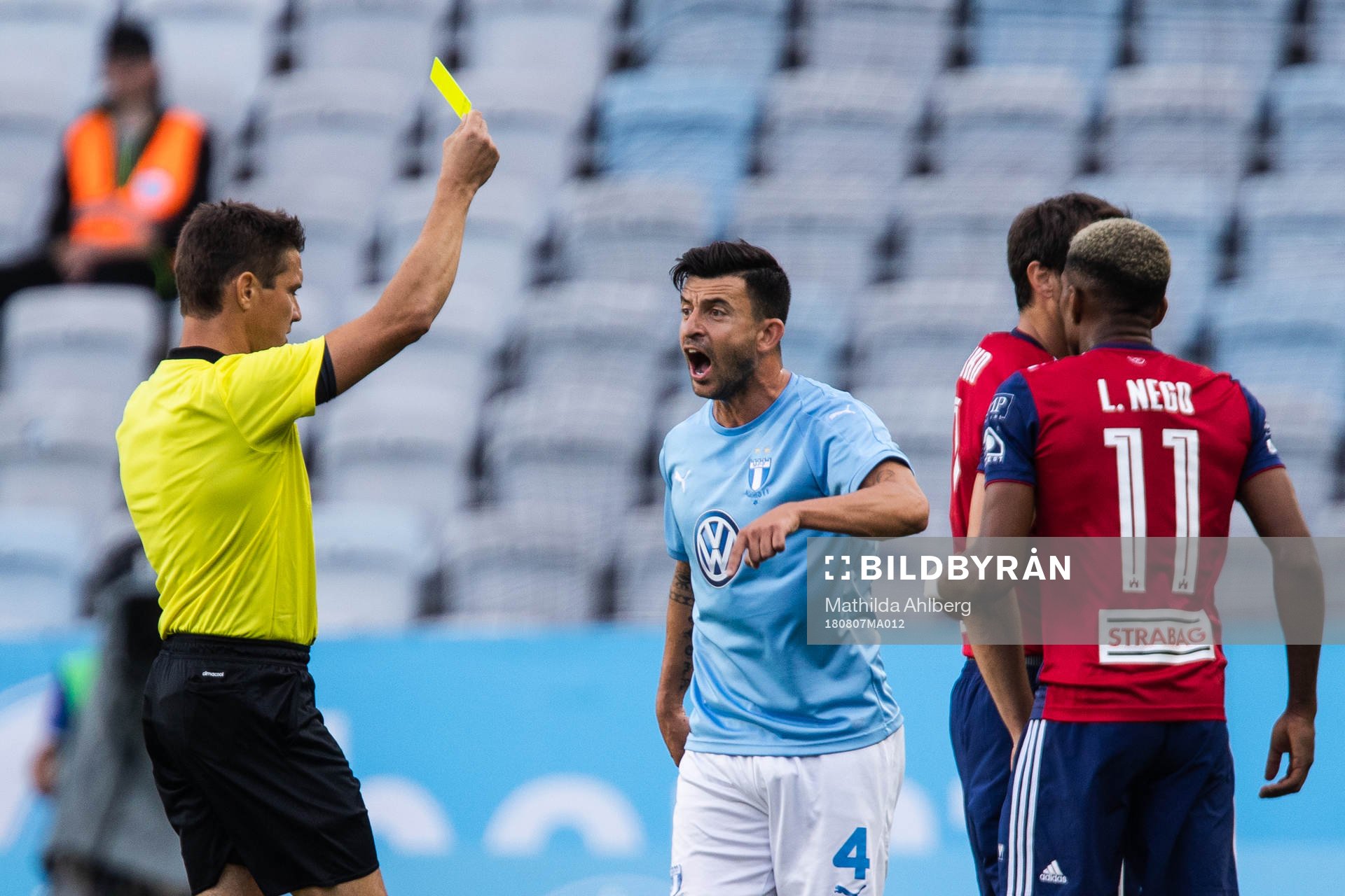 Behrang Safari of Malmö FF gets a yellow card from referee
