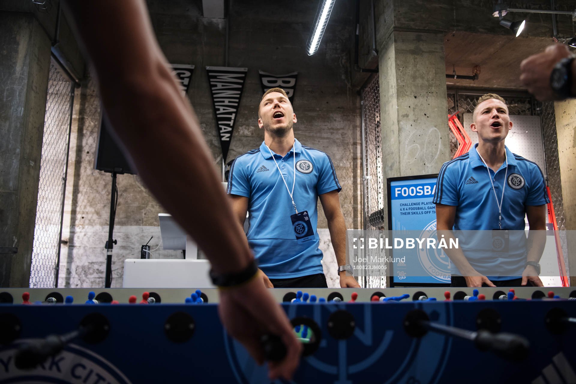 Anton Tinnerholm (L) plays foosball with teammates at a