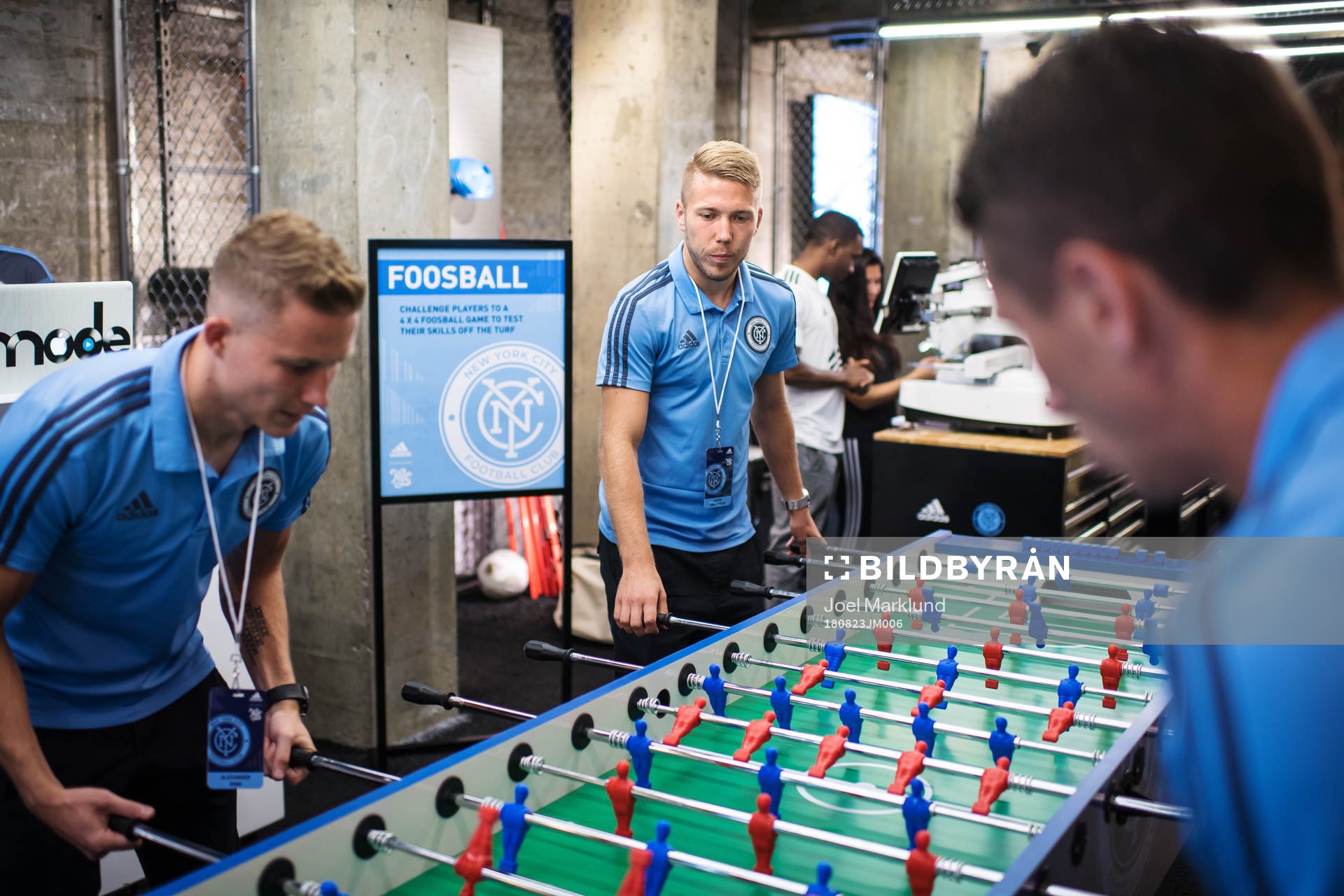 Anton Tinnerholm plays foosball with teammates at a press