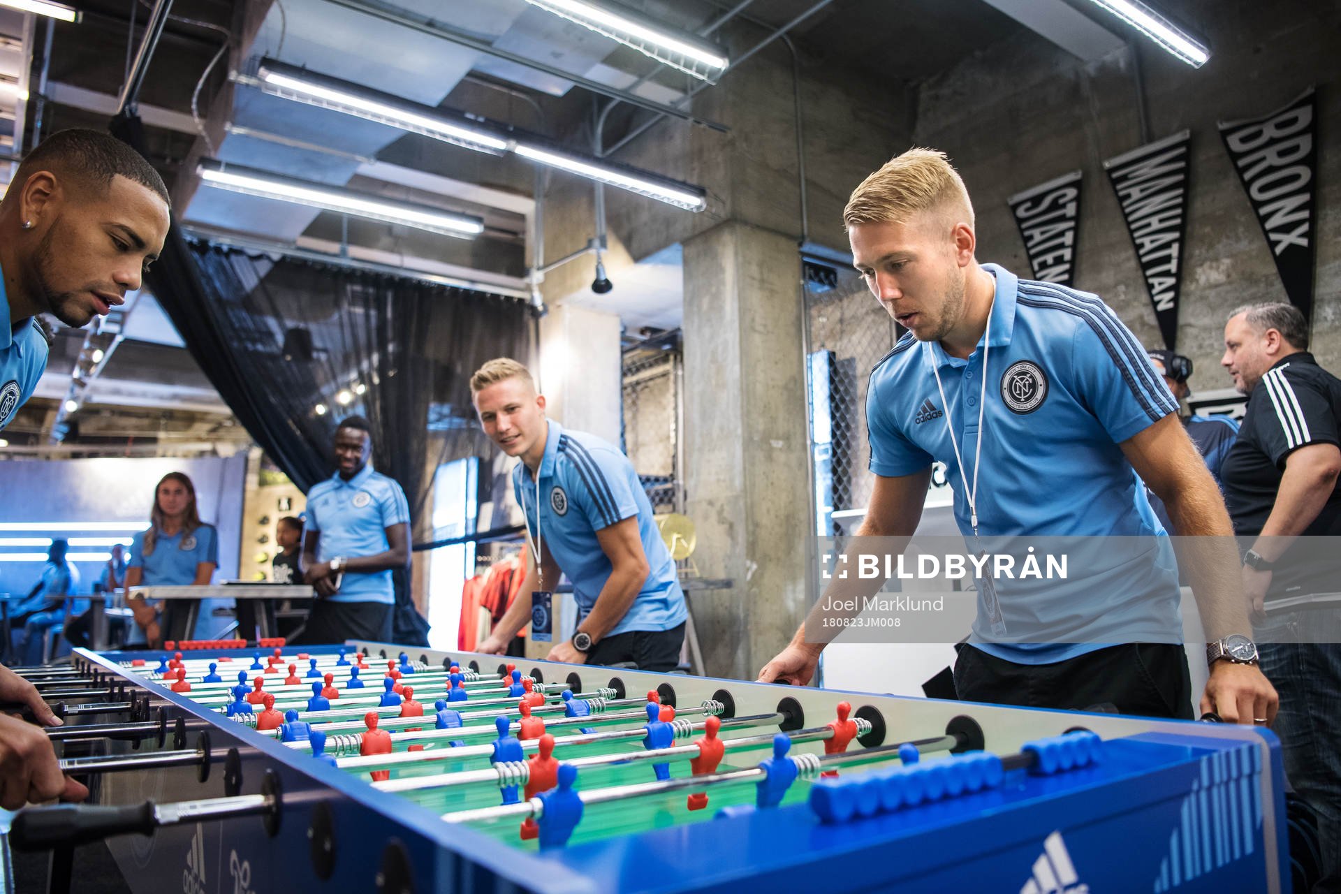 Anton Tinnerholm (R) plays foosball with teammates at a