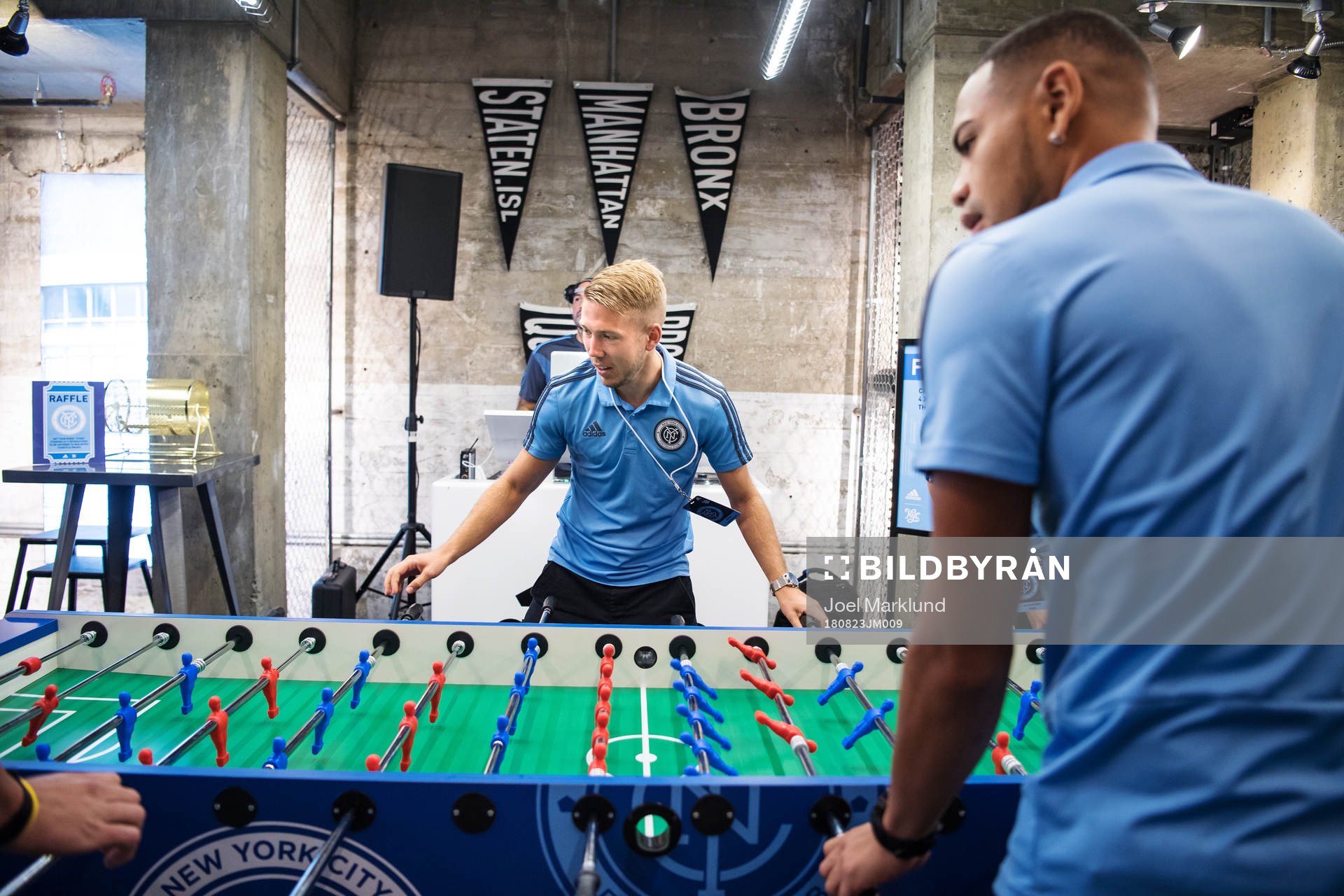 Anton Tinnerholm plays foosball with teammates at a press