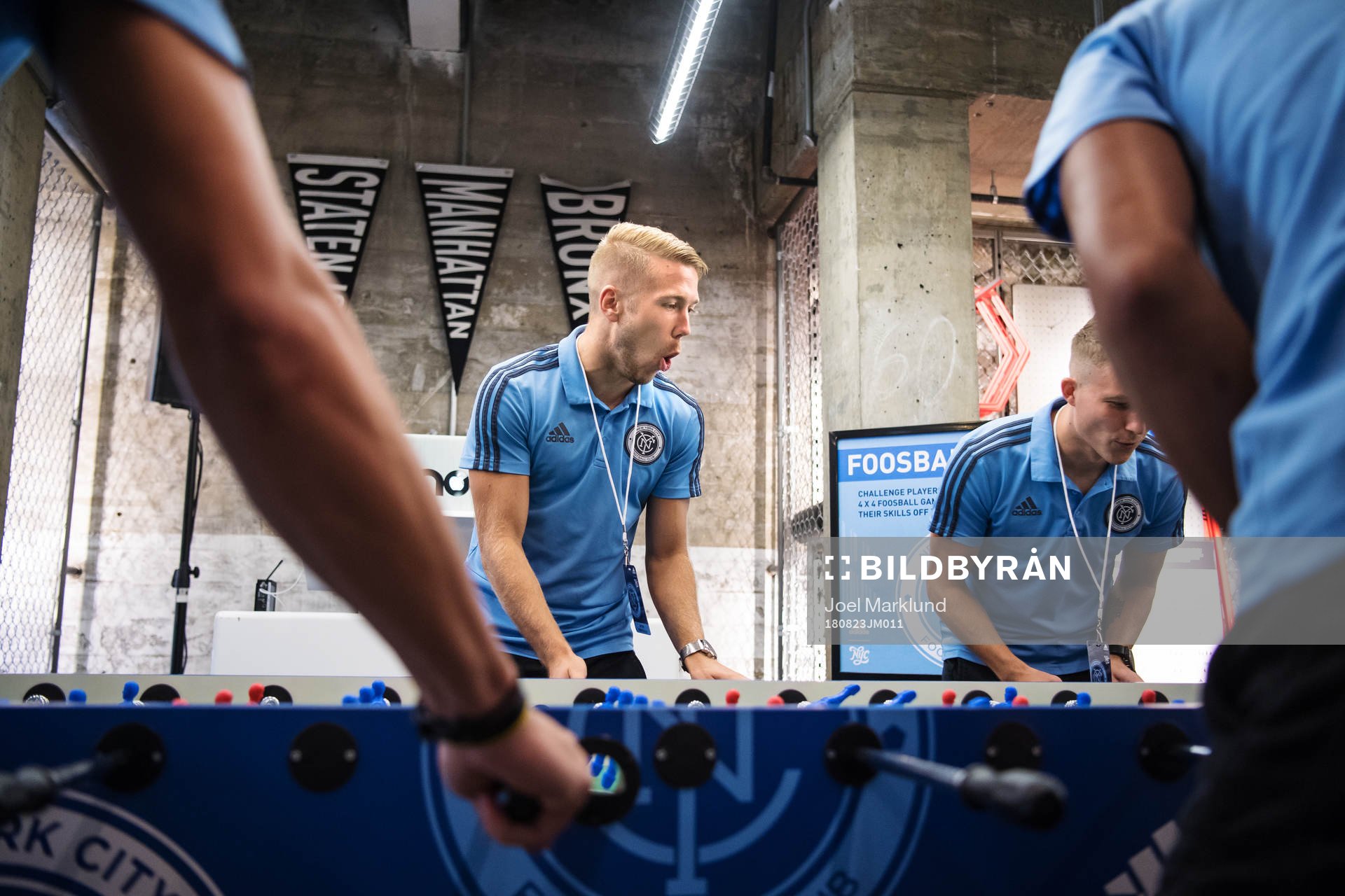Anton Tinnerholm plays foosball with teammates at a press