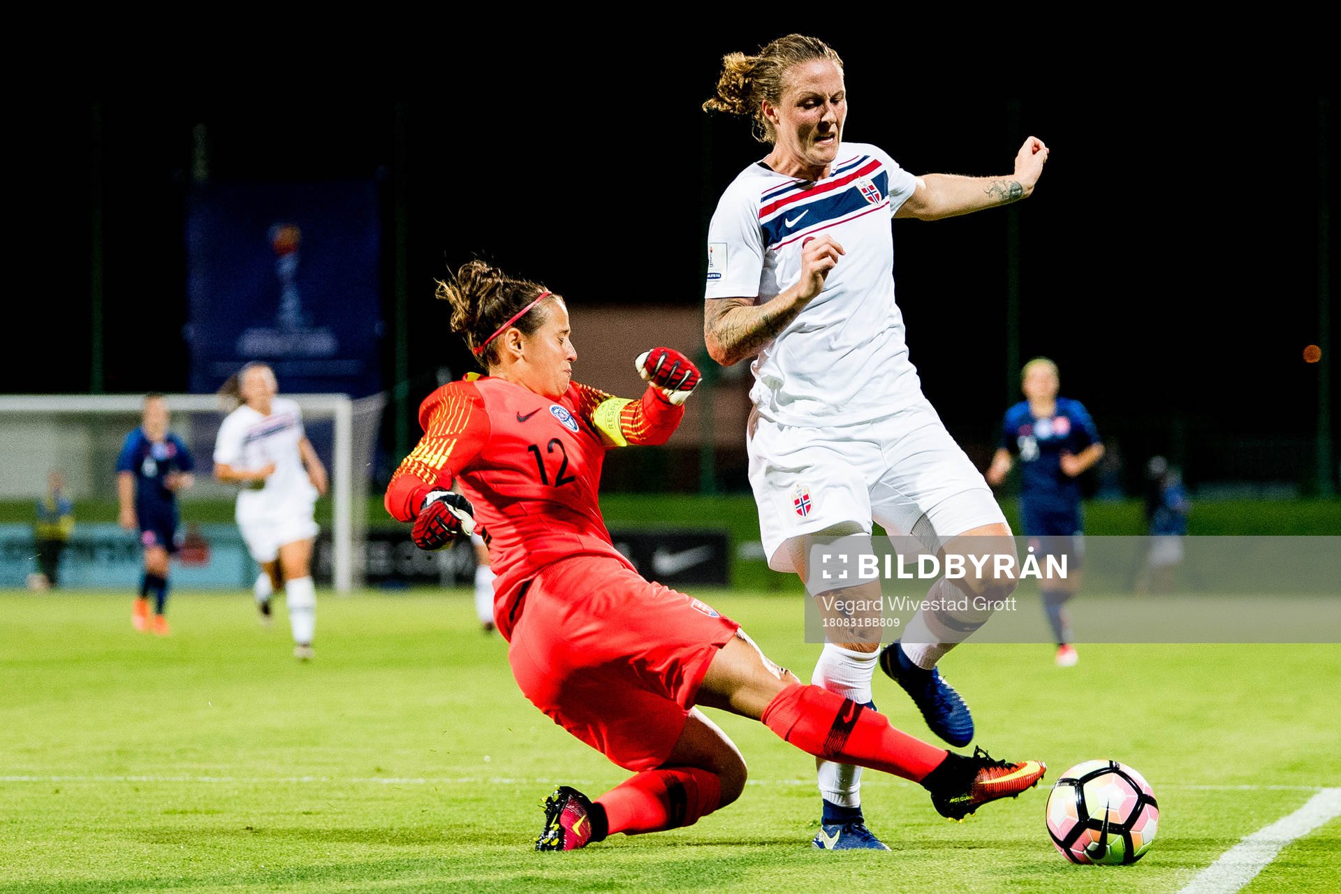 Isabell Herlovsen of Norway is being tackled by goalkeeper