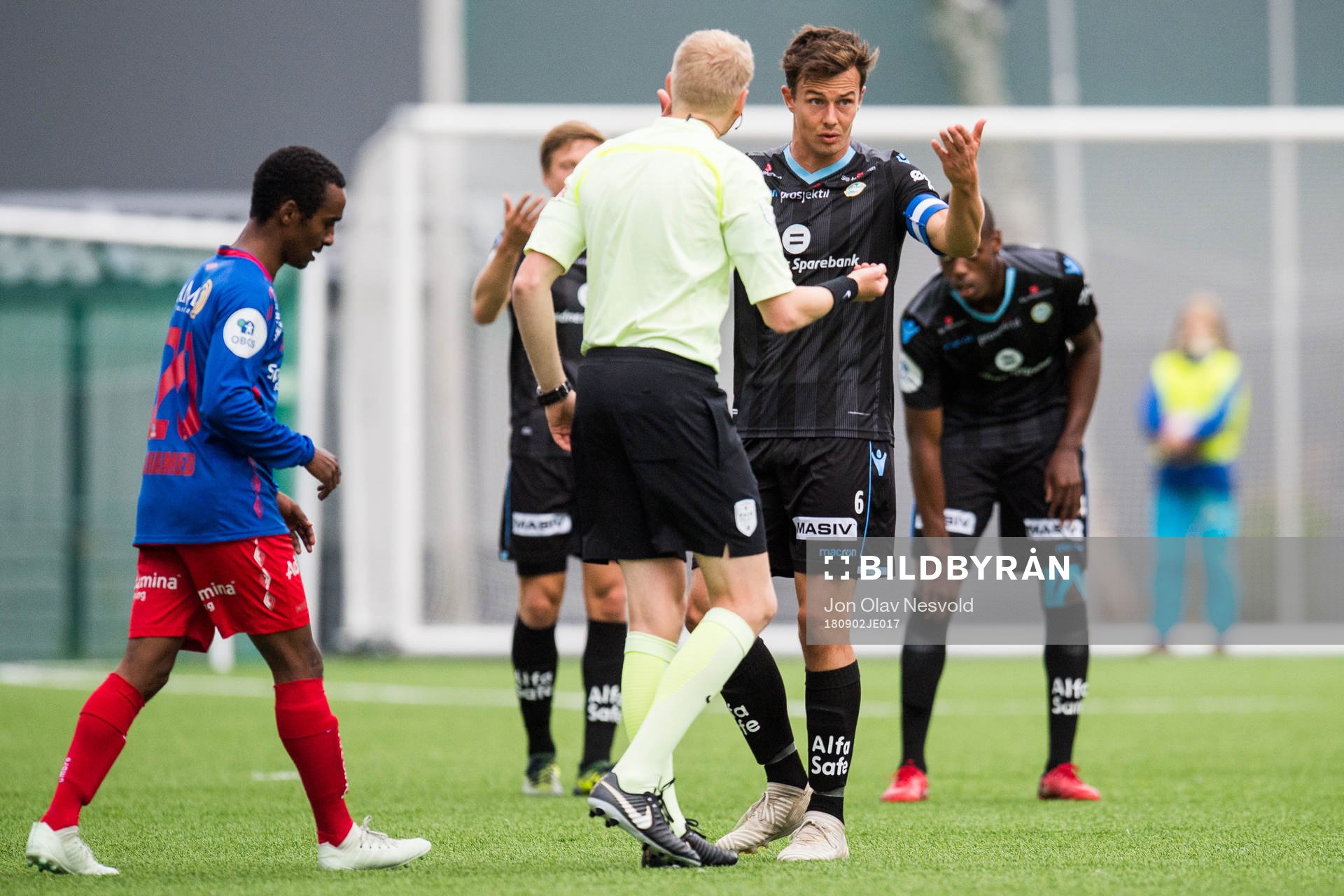 Eivind Bodding, referee, and Niels Vorthoren of Sandnes Ulf