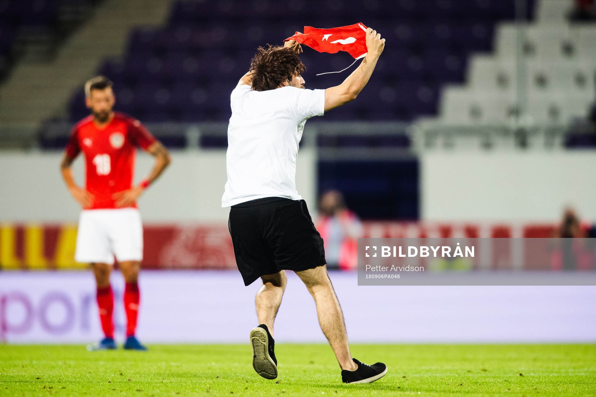 A pitch invader is wrestled by security