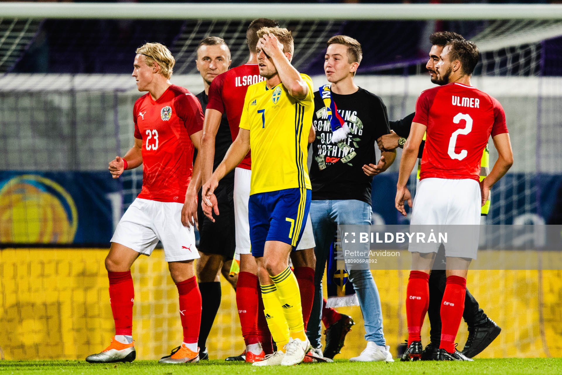 A pitch invader among Sebastian Larsson of Sweden and