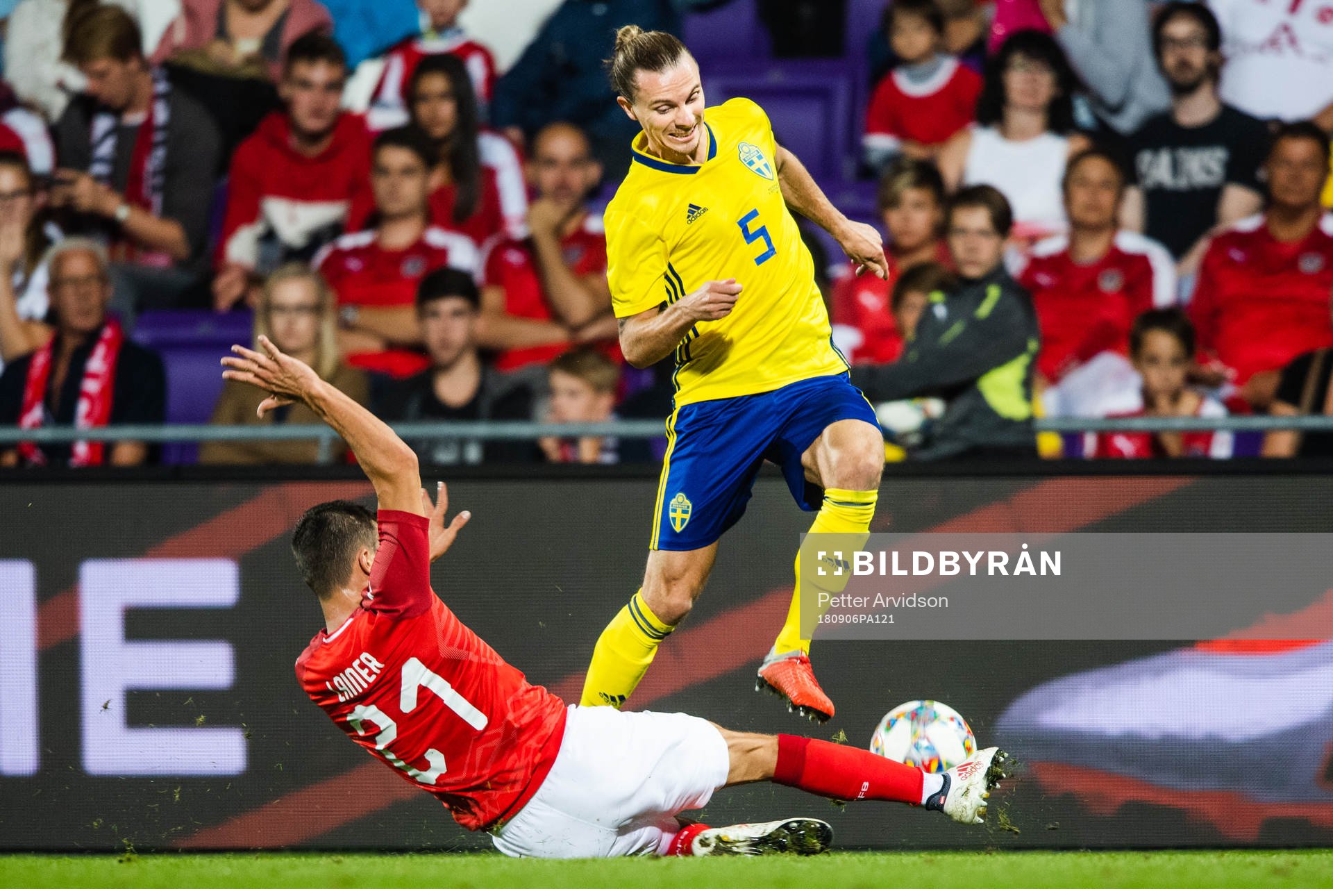 Stefan Lainer of Austria slide tackles Niklas Hult of Sweden