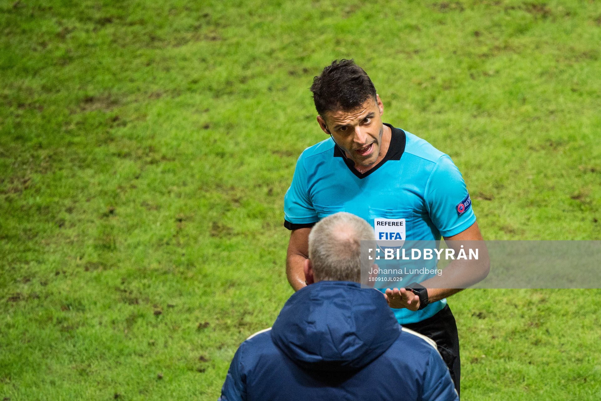 Referee Jesus Gil Manzano talks to head coach Janne