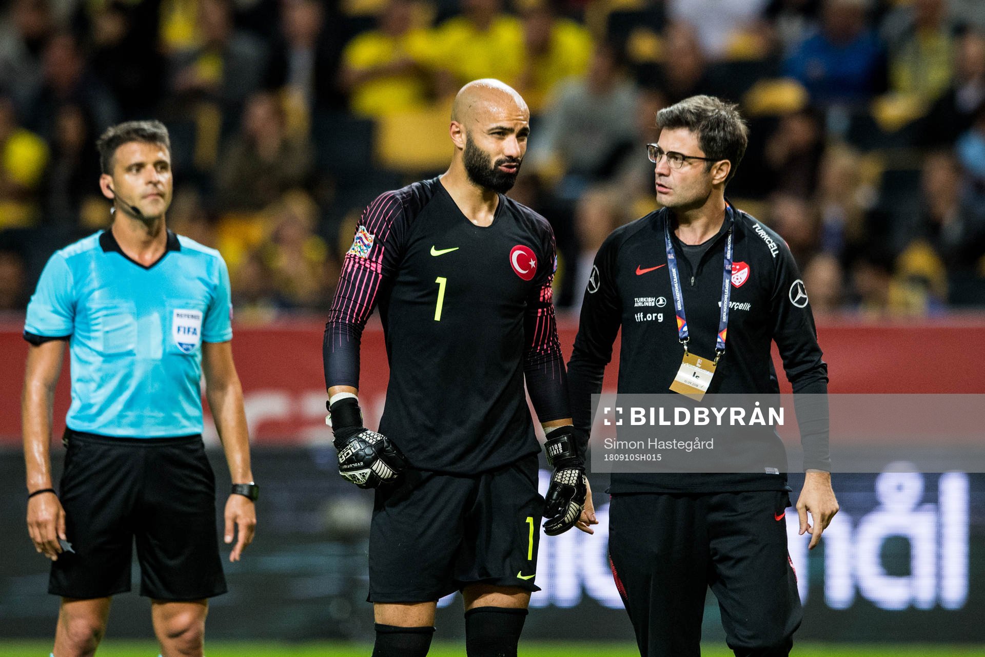 Goalkeeper Sinan Bolat of Turkey with a team staff