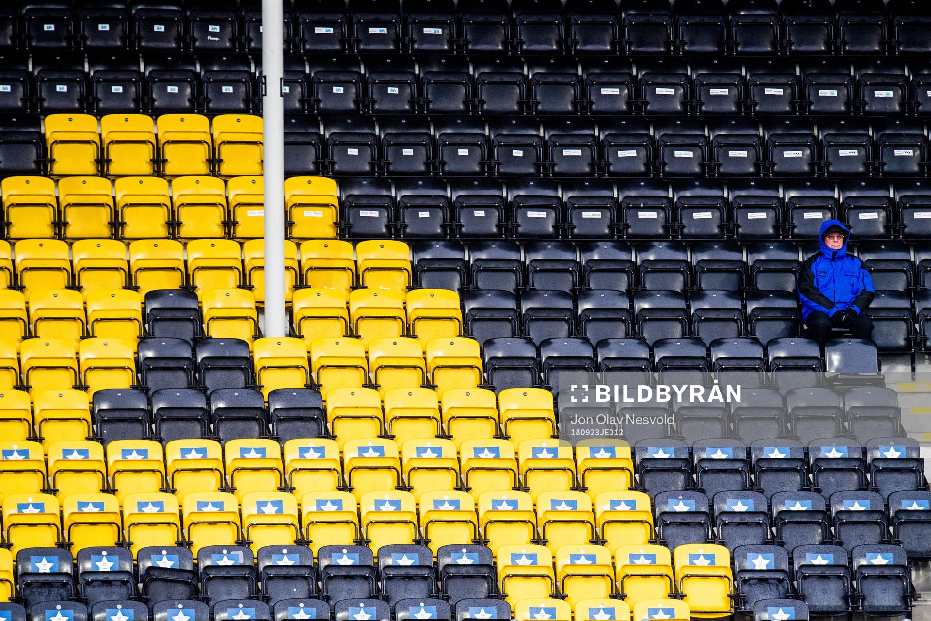 A spectator and empty seats