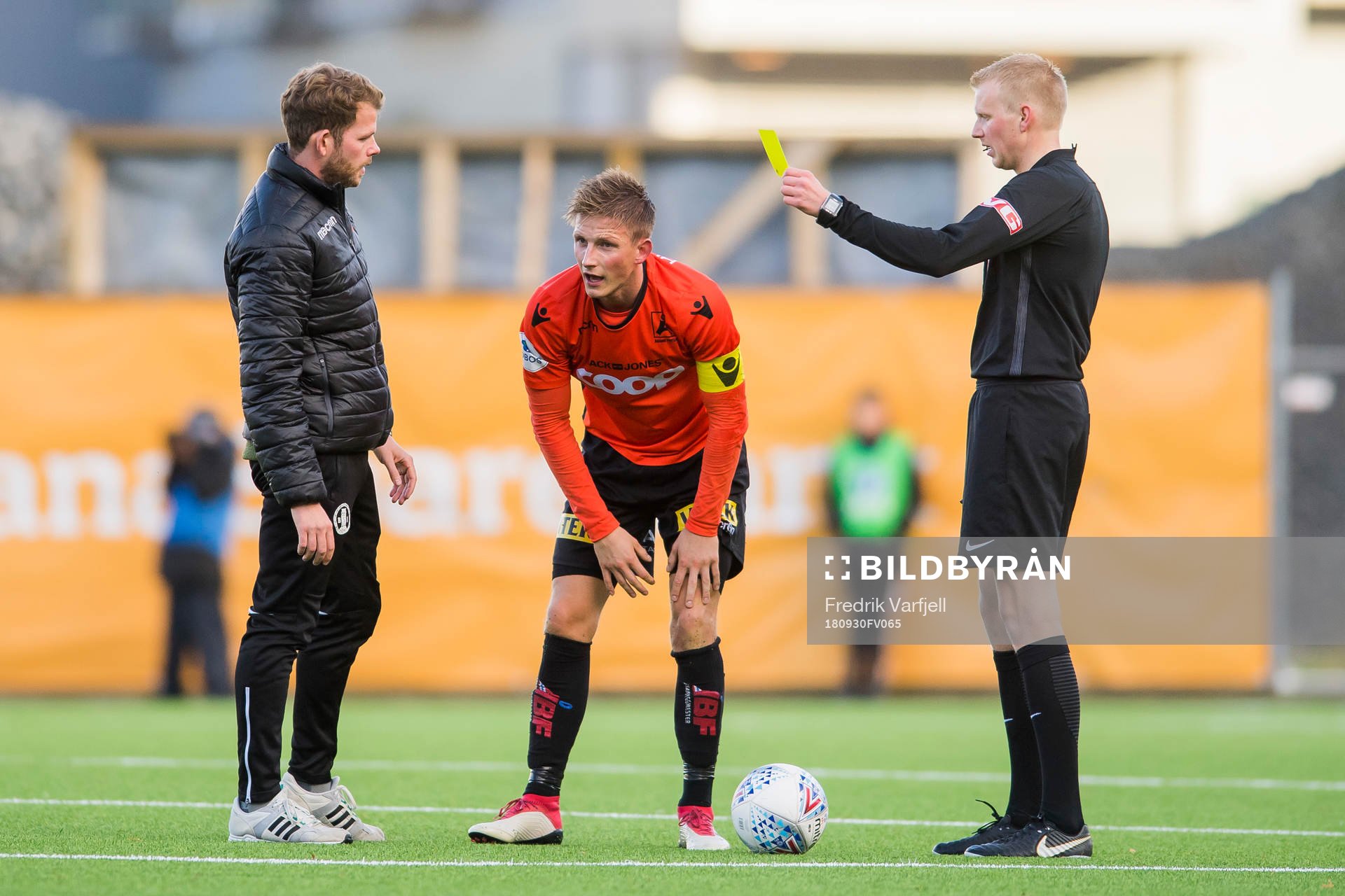 Jonas Hestetun of Åsane is shown a yellow card by referee Eivind Bodding during the OBOS-ligaen match between Åsane and Sandnes Ulf on September 30, 2018 in Åsane.