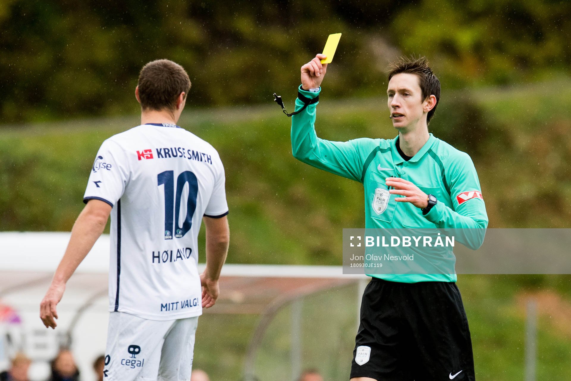 Tommy Høiland of Viking is shown a yellow card by Sivert Øksnes Amland, referee, during the OBOS-ligaen match between Florø and Viking on September 30, 2018 in Florø.