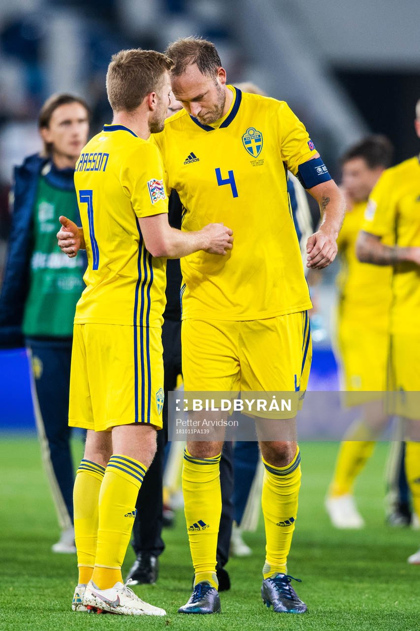 Sebastian Larsson and Andreas Granqvist of Sweden looks