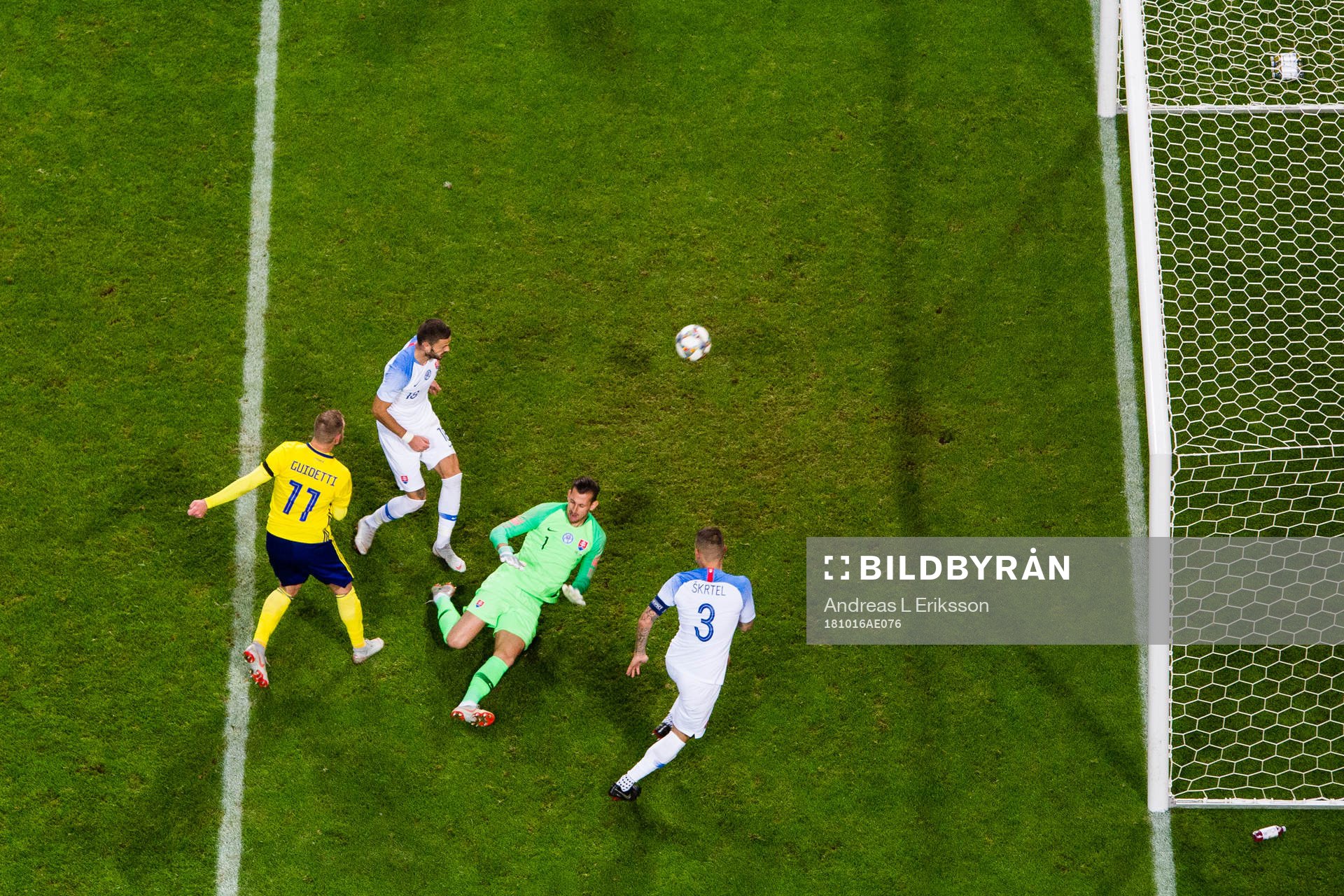 John Guidetti of Sweden scores 1-0 behind goalkeeper Martin