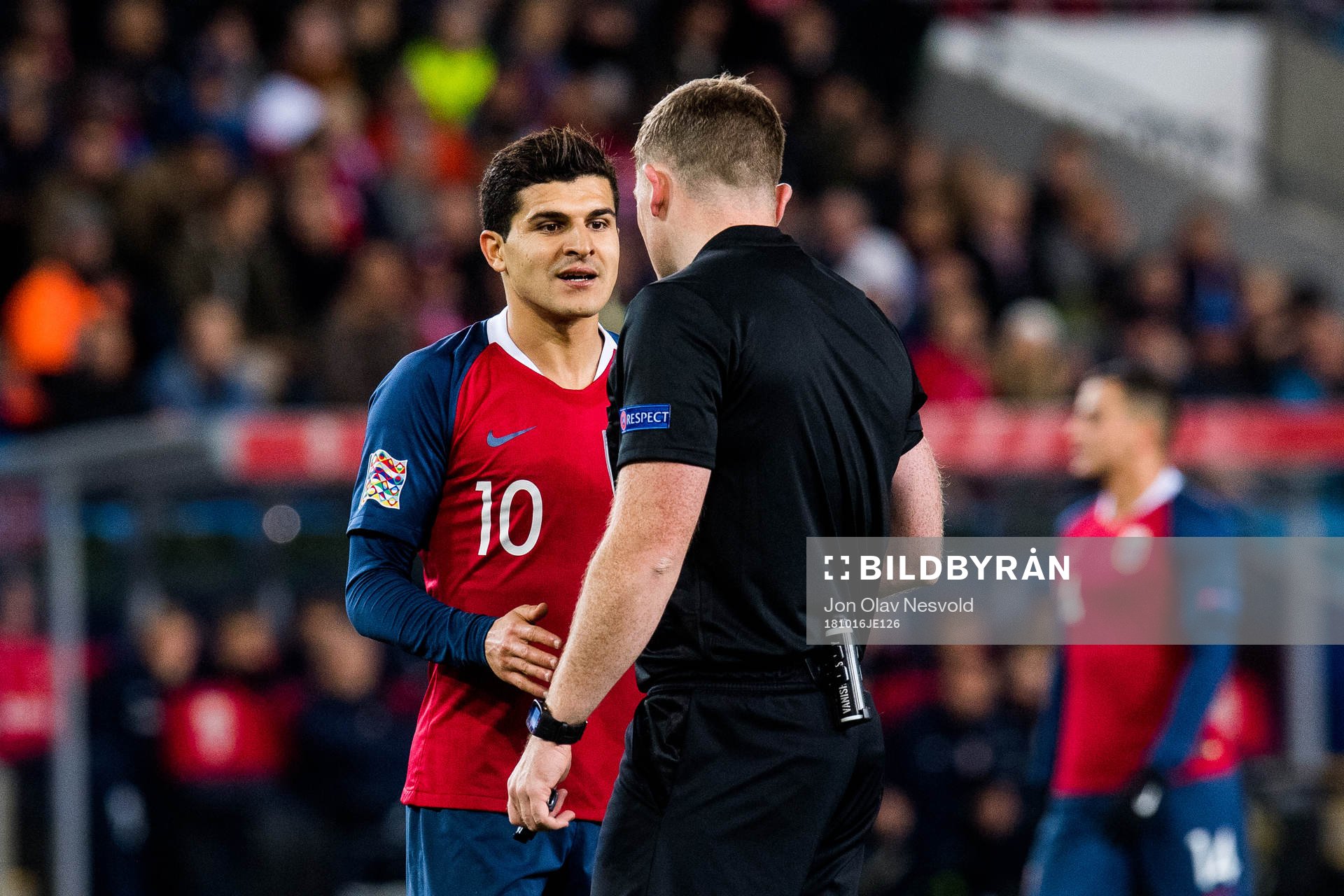 Tarik Elyounoussi of Norway and referee John Beaton of