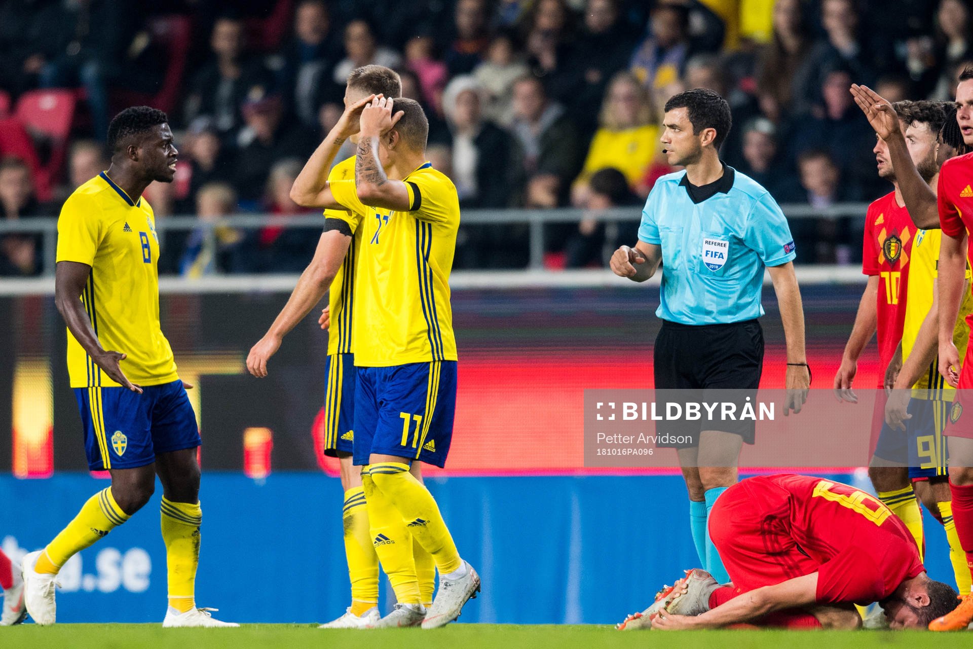Referee Frank Schneider and Isak Ssewankambo of Sweden