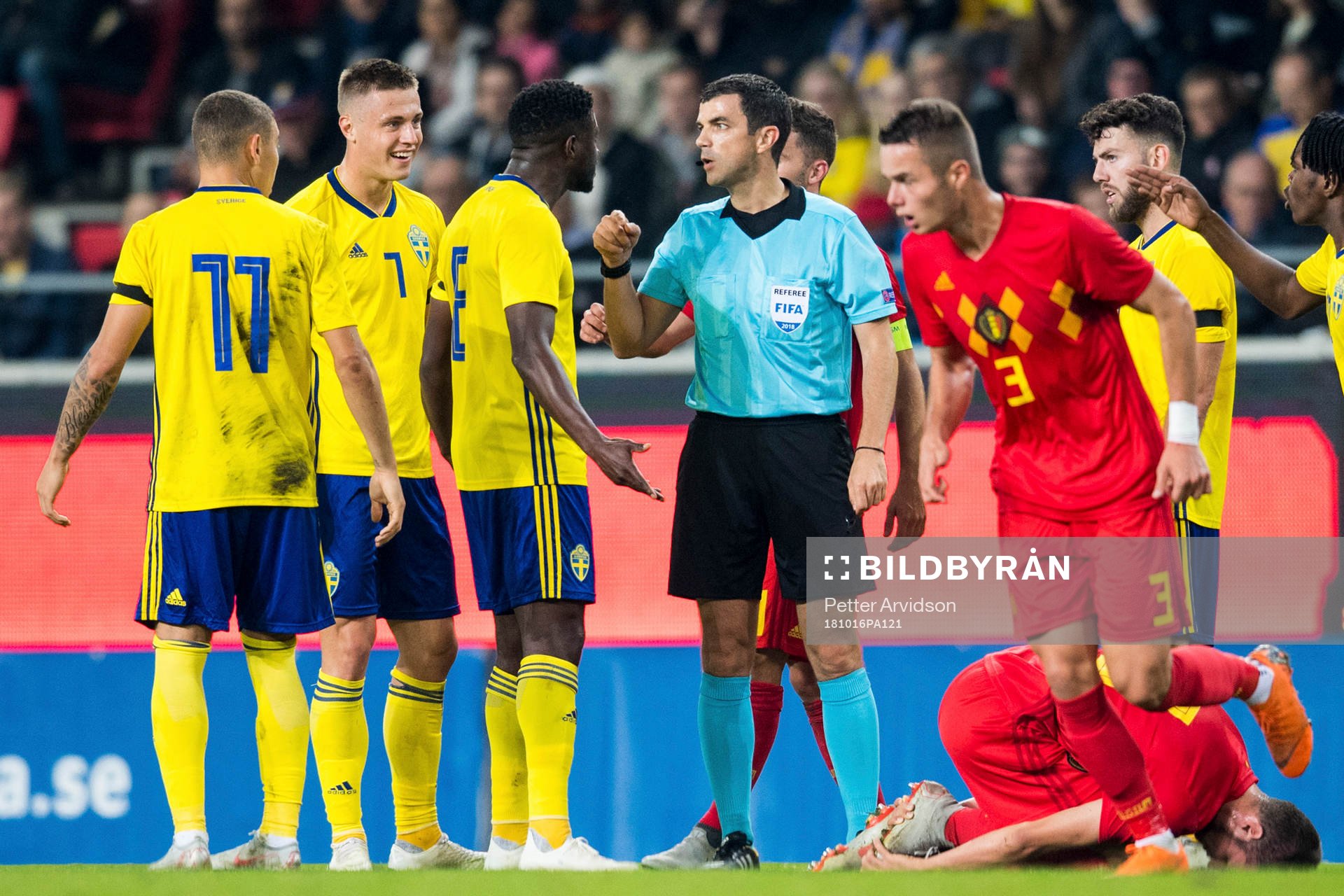Referee Frank Schneider and Isak Ssewankambo of Sweden