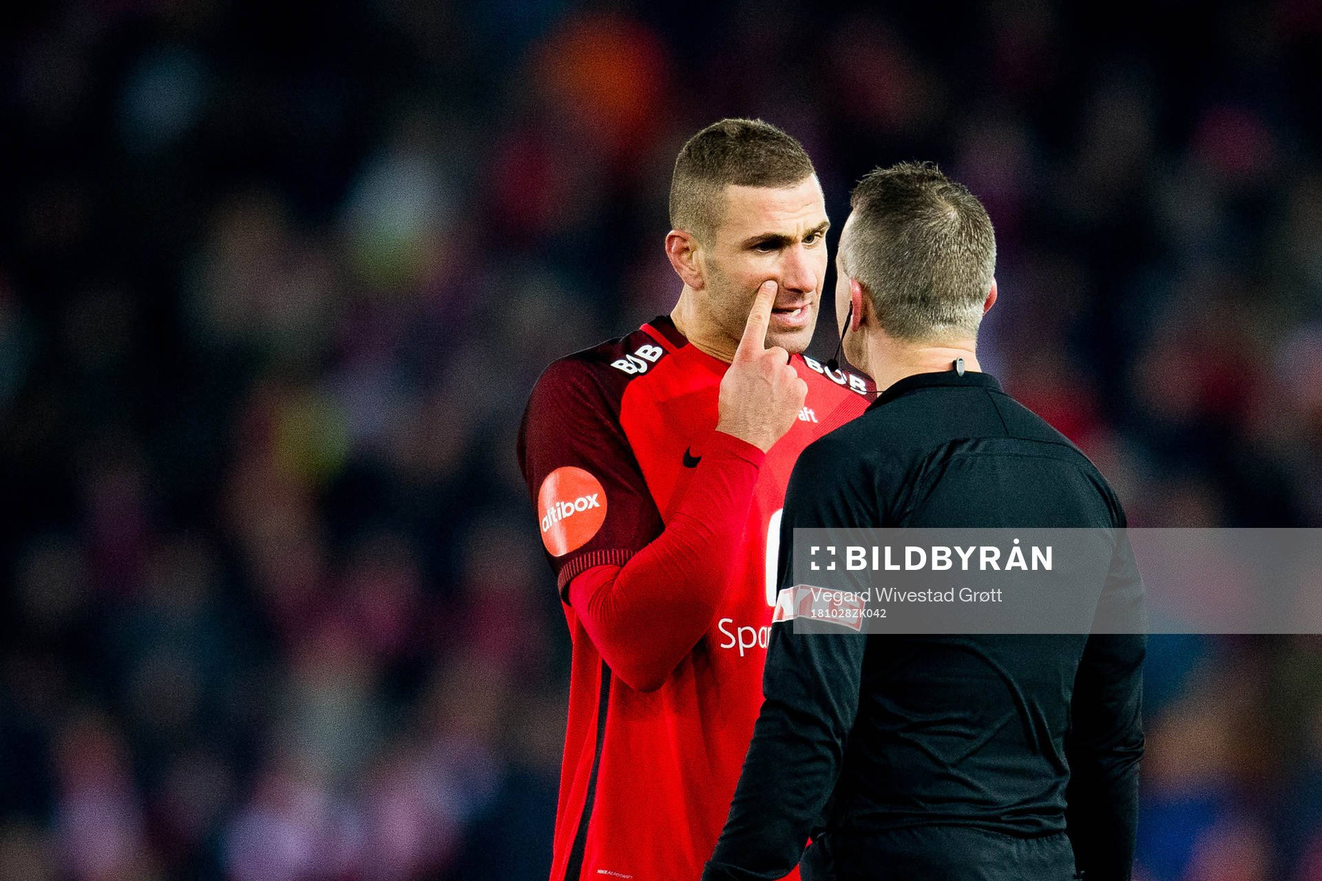 Azar Karadas of Brann argues with Svein Oddvar Moen, referee