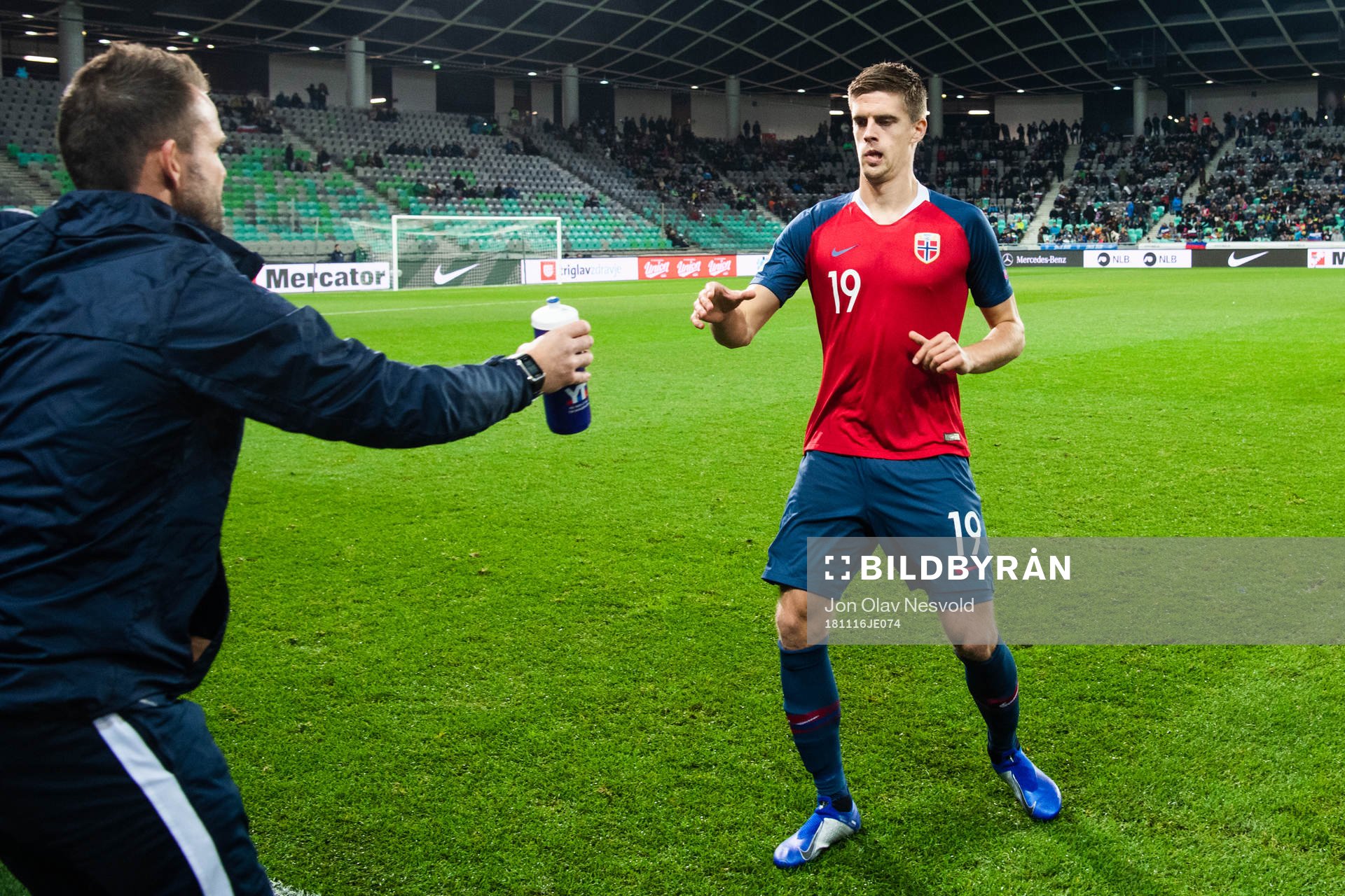 Markus Henriksen of Norway is handled a bottle