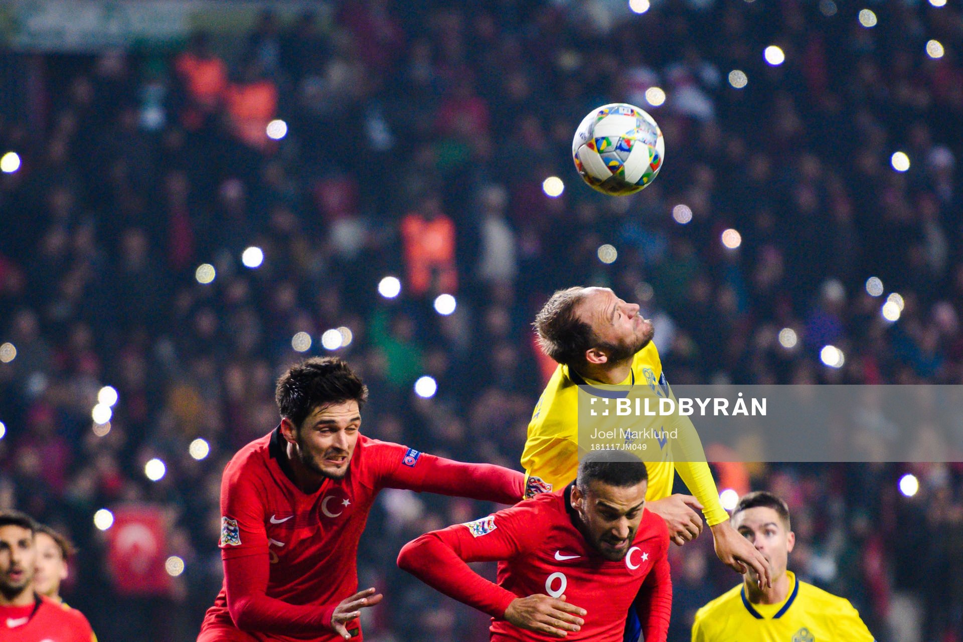 Okay Yokuslu and Cenk Tosun of Turkey in a duel with Andreas Granqvist of Sweden during the Nations League football match between Turkey and Sweden on November 17, 2018 in Konya.