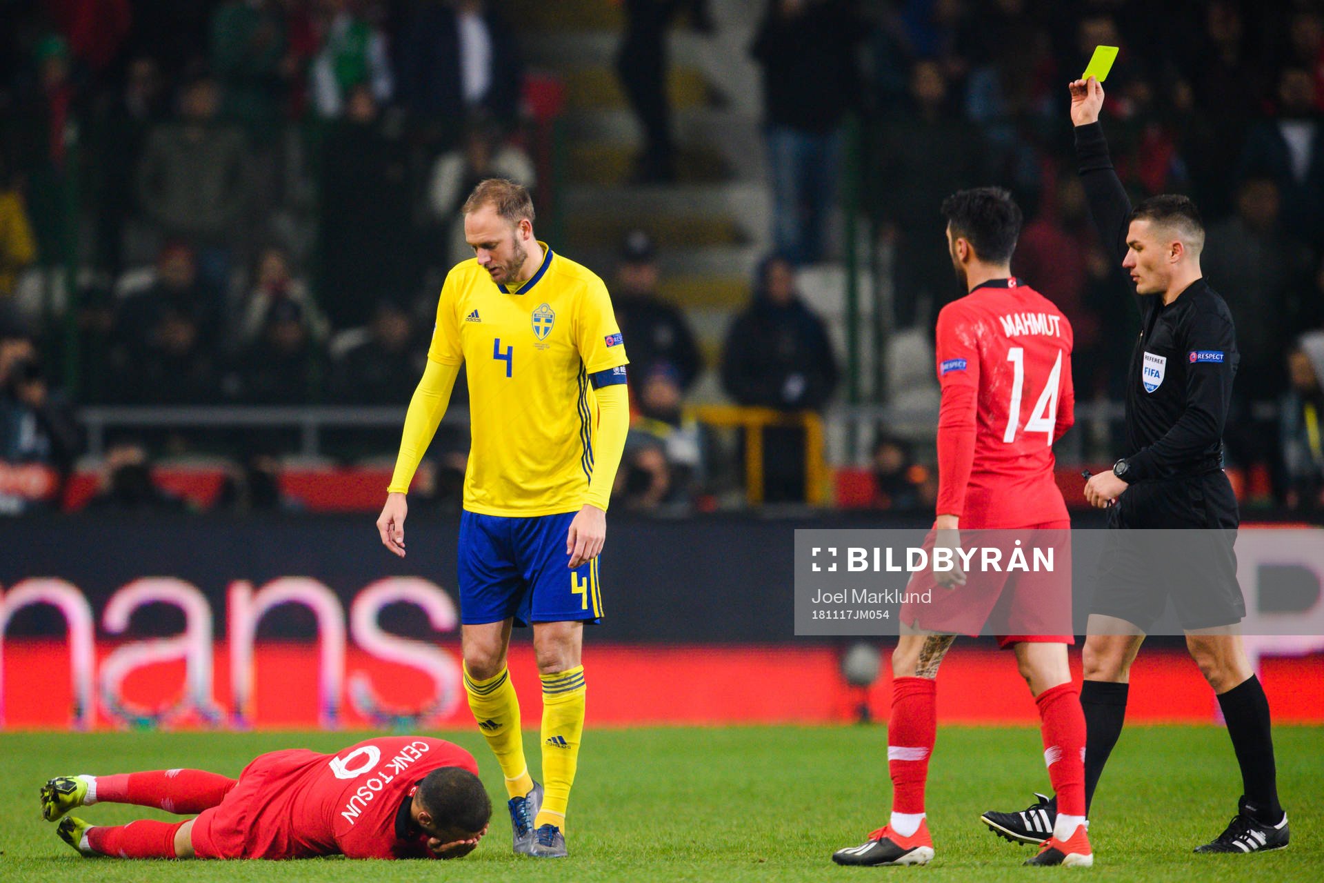 Andreas Granqvist of Sweden receives a yellow card from