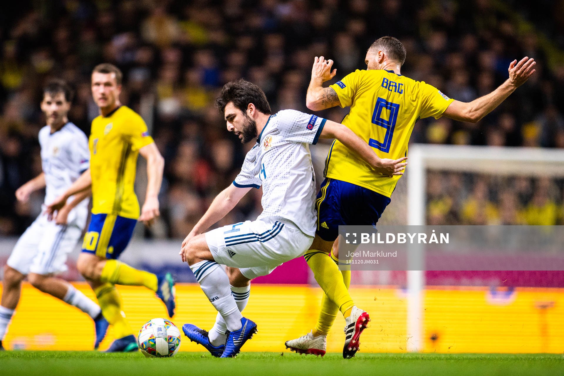 Giorgi Dzhikiya of Russia and Marcus Berg of Sweden