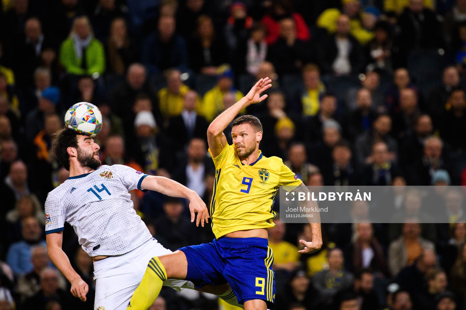 Giorgi Dzhikiya of Russia and Marcus Berg of Sweden