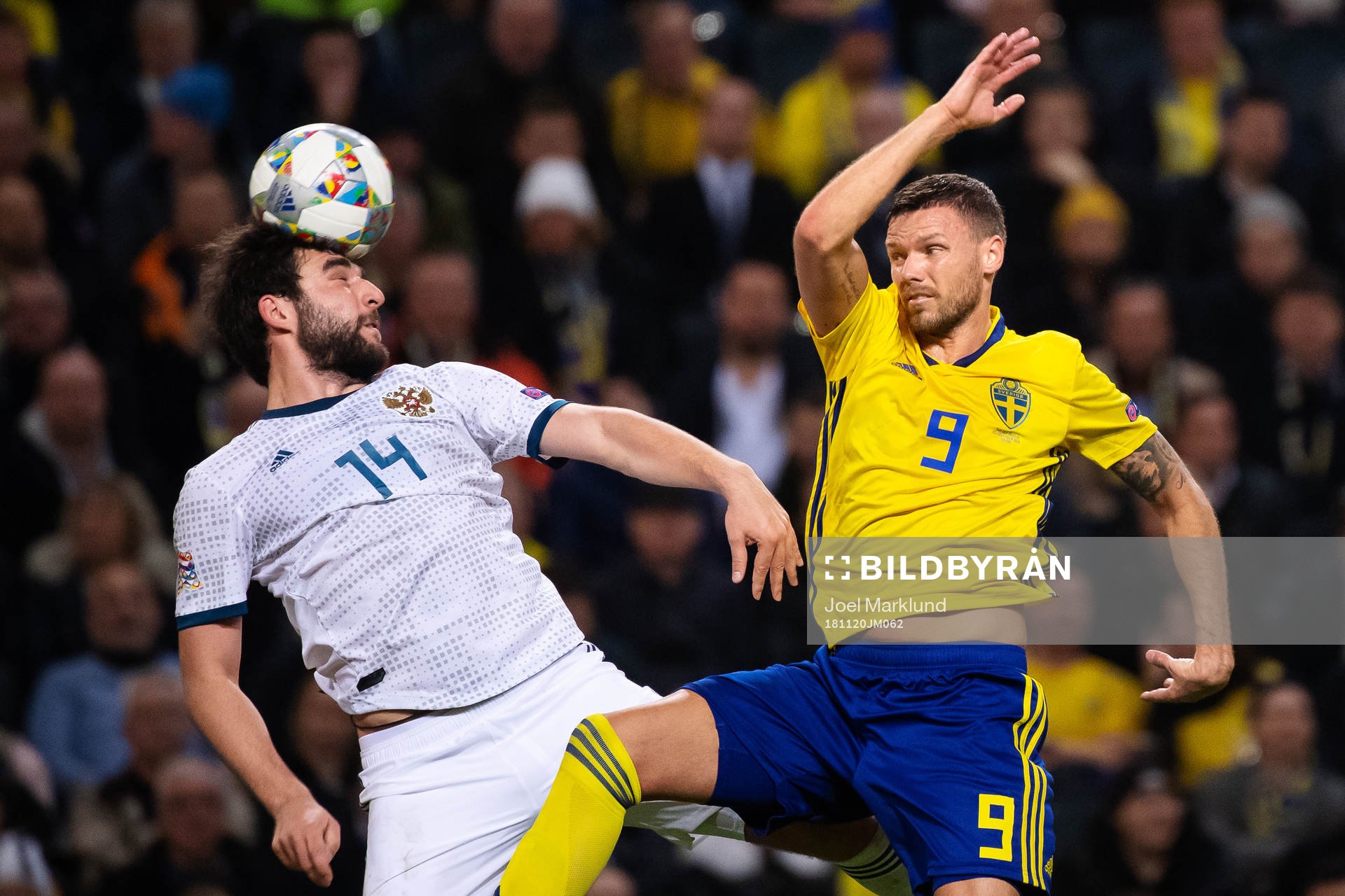 Giorgi Dzhikiya of Russia and Marcus Berg of Sweden