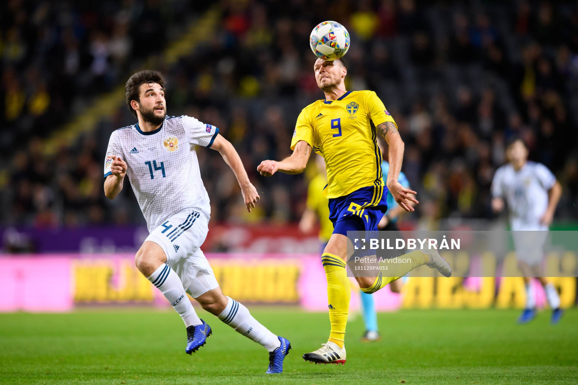 Giorgi Dzhikiya of Russia and Marcus Berg of Sweden