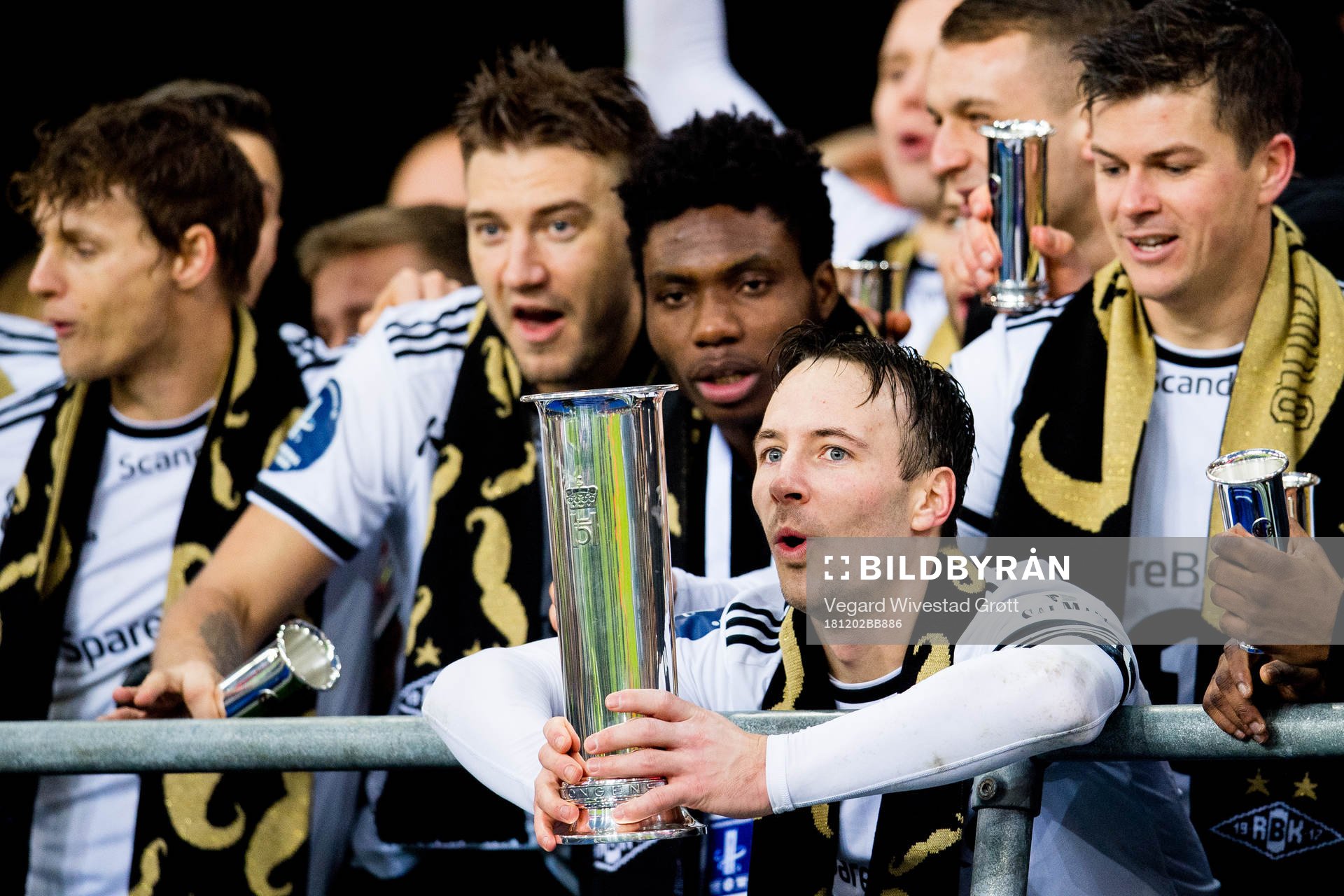 Mike Jensen of Rosenborg lifts the trophy in front of