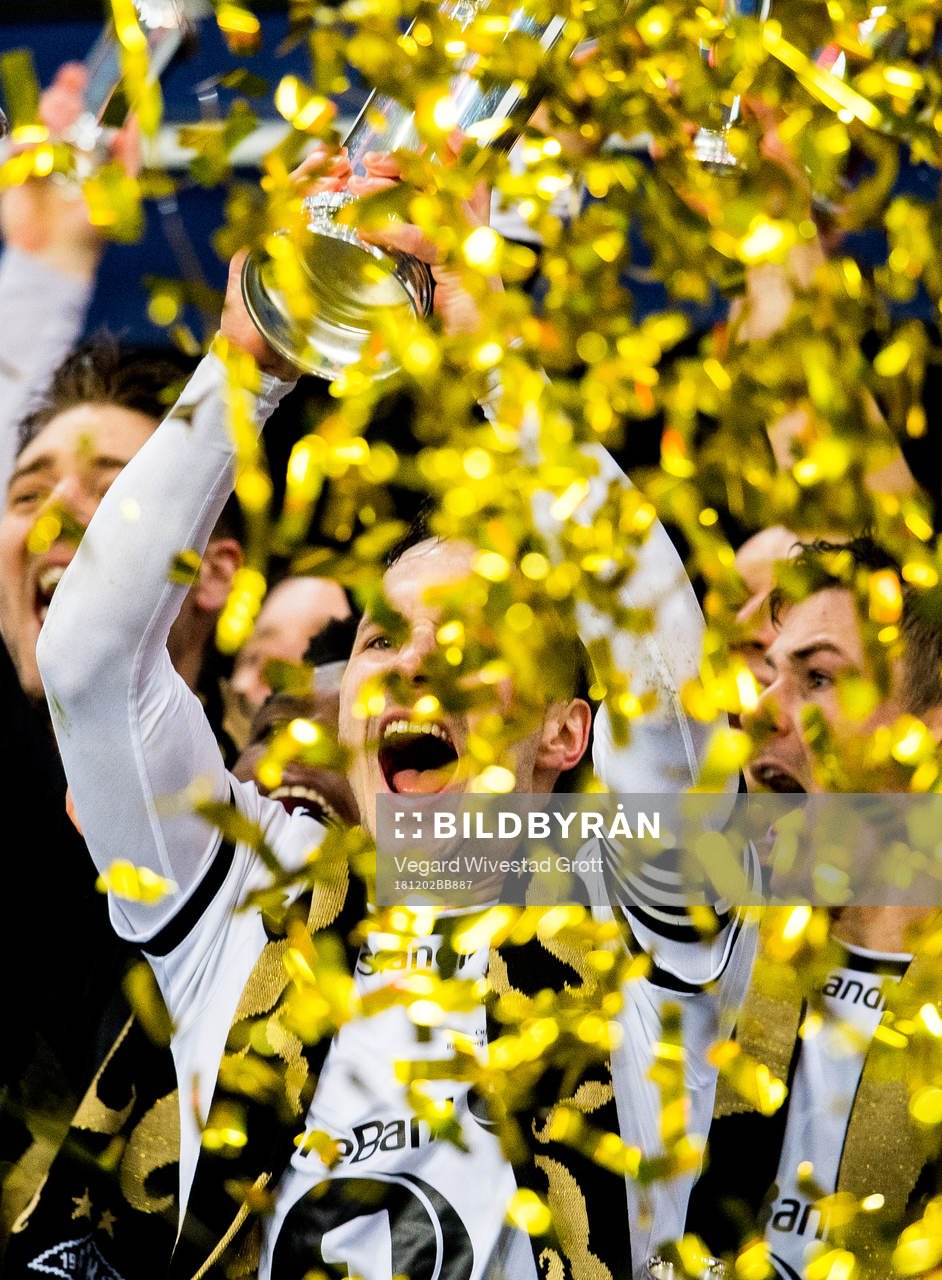 Mike Jensen of Rosenborg lifts the trophy in front of