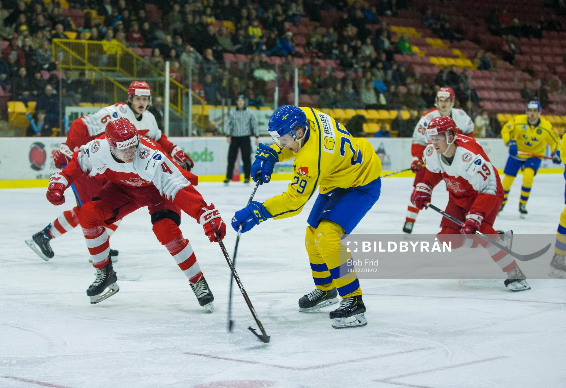 Denmark defenceman Lasse Mortensen (4)  checks Sweden