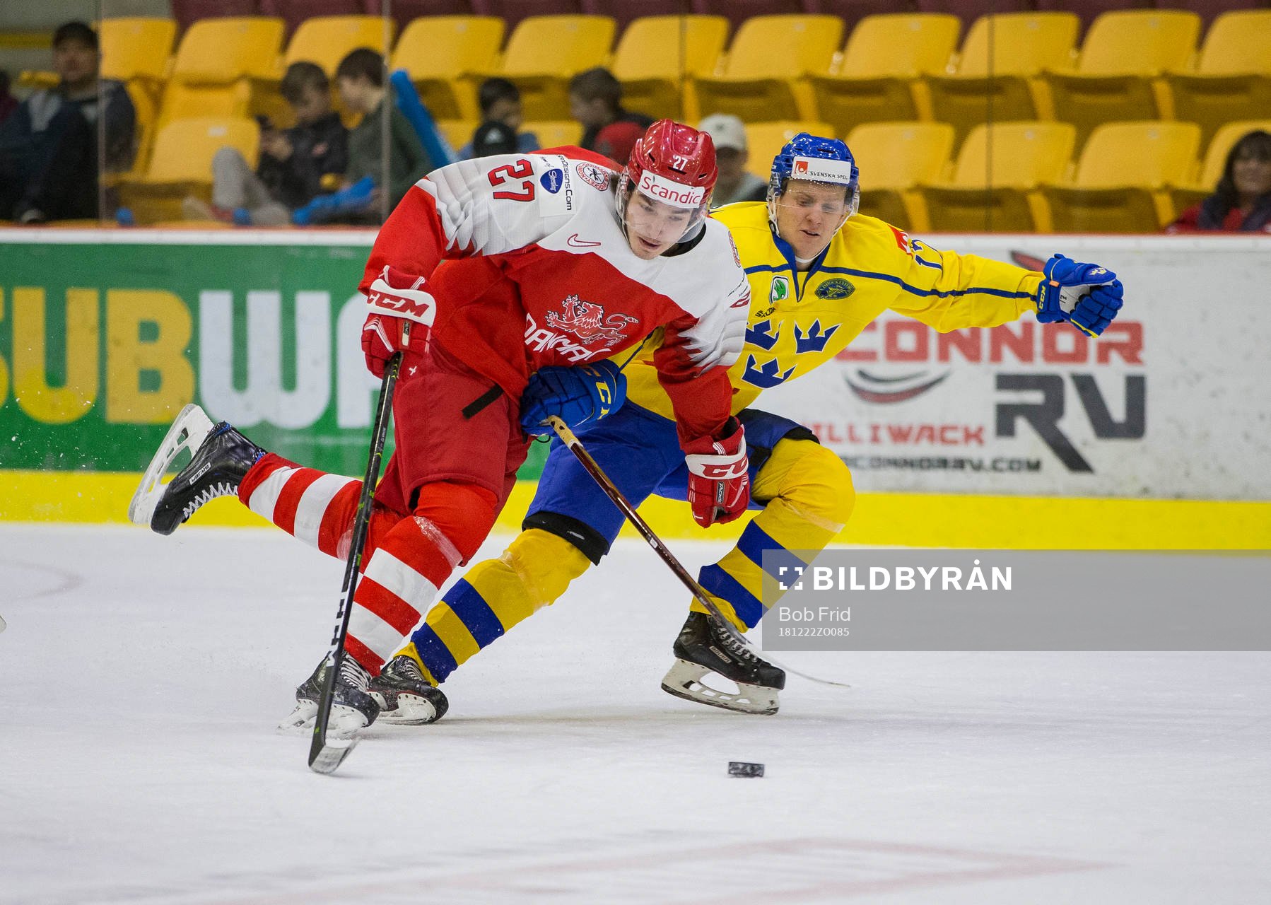Sweden forward Filip Sveningsson (17)  checks Denmark