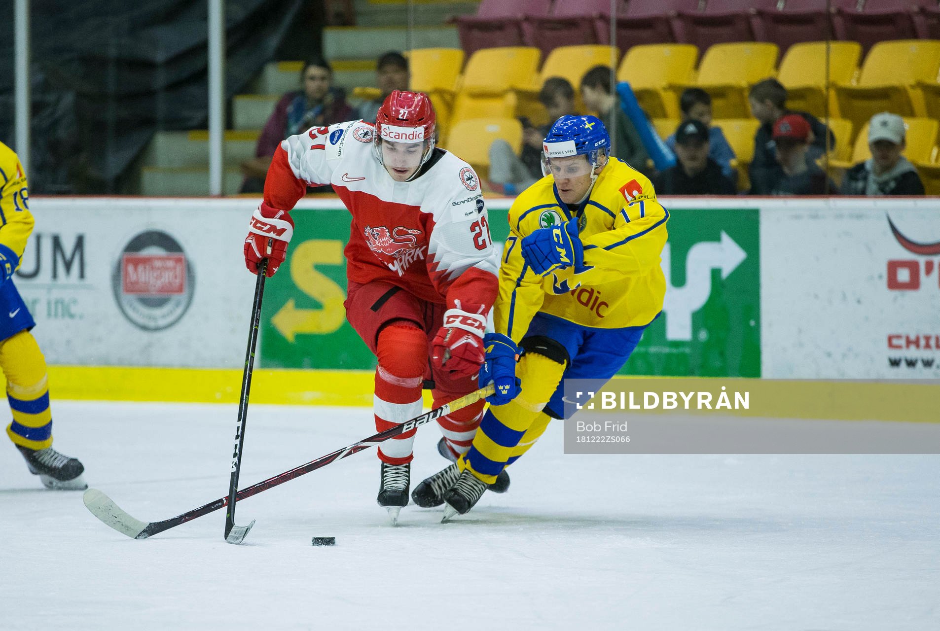 Sweden forward Filip Sveningsson (17)  checks Denmark