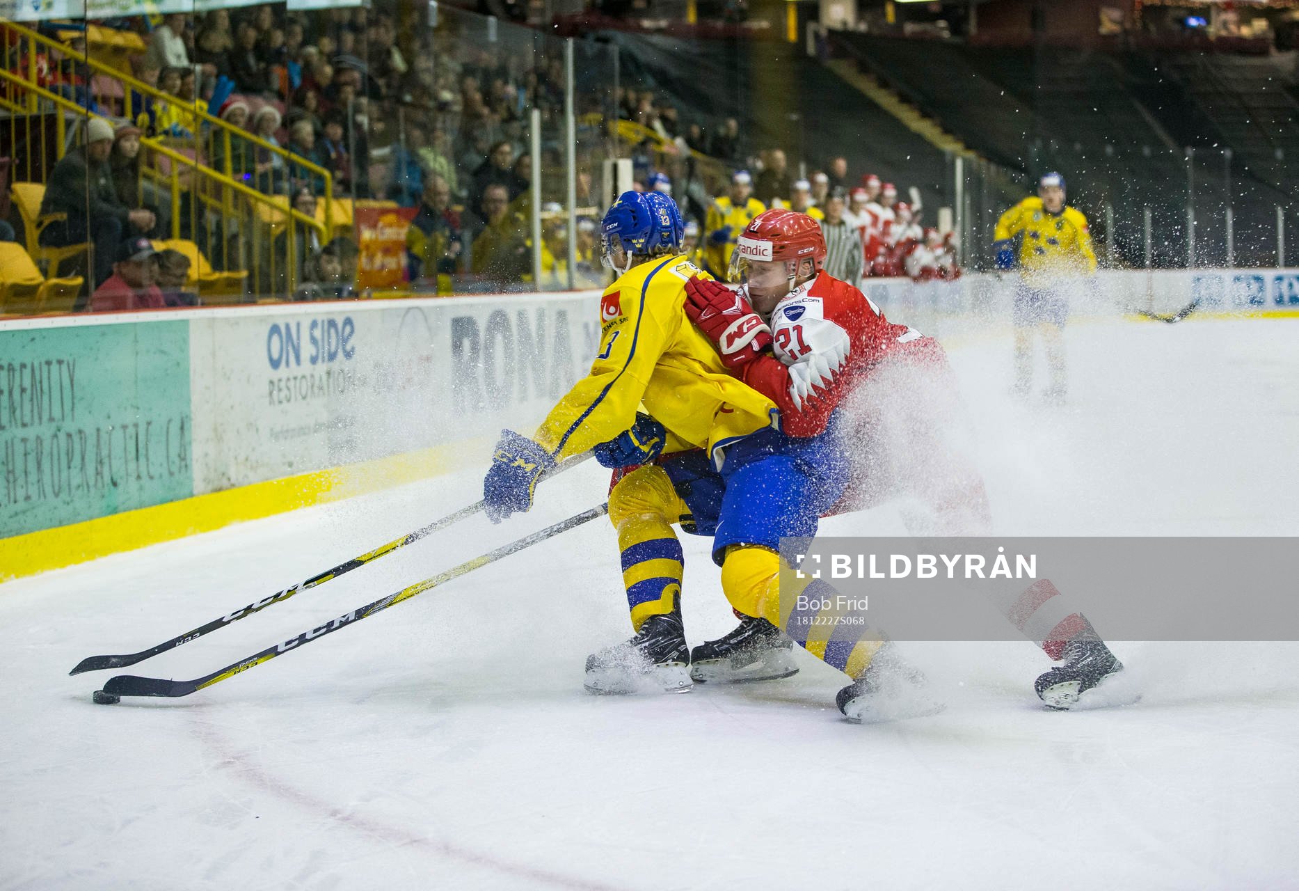 Denmark forward Gustav Green (21)  checks Sweden forward