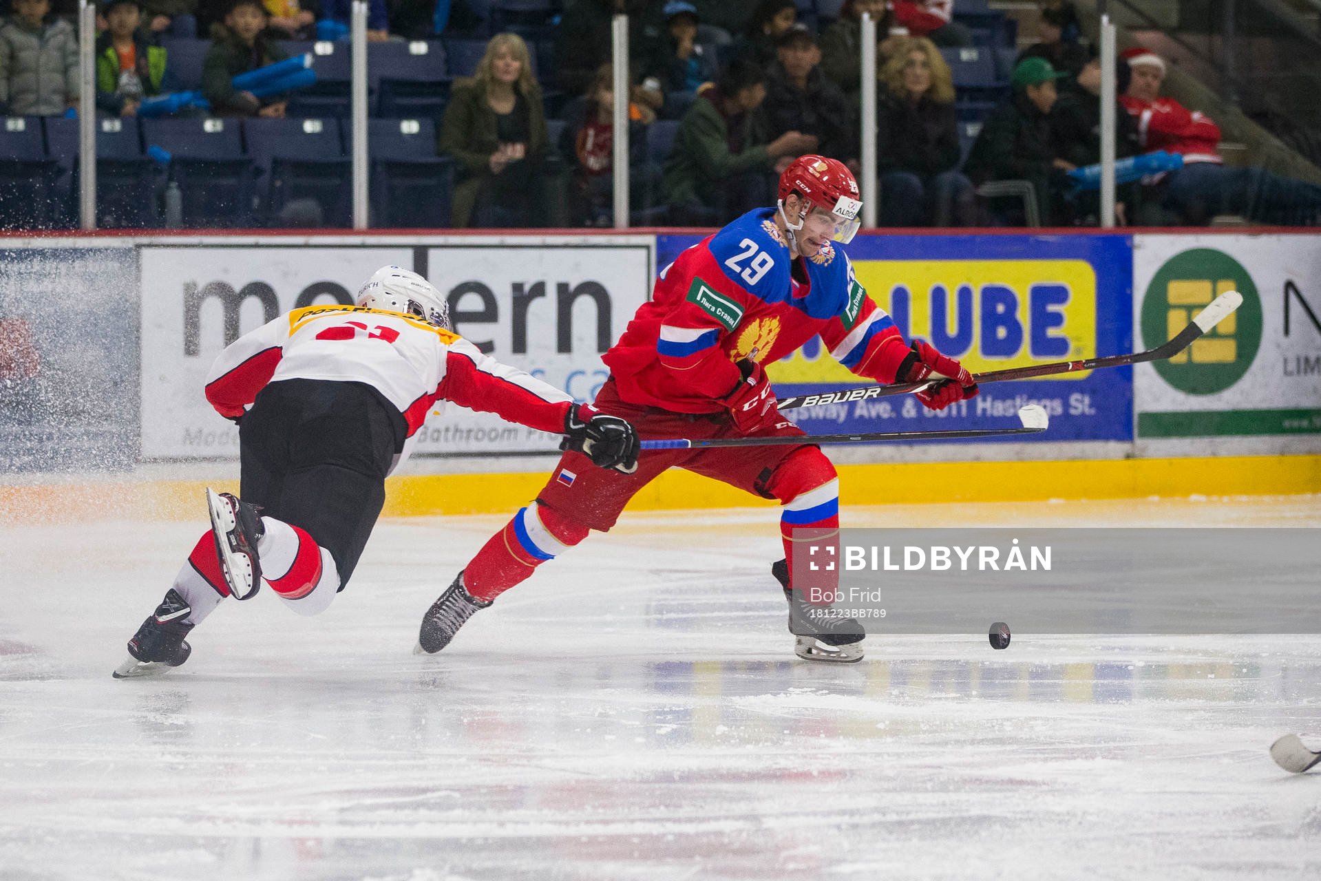 Switzerland defenceman Tim Berni (21)  checks Russia