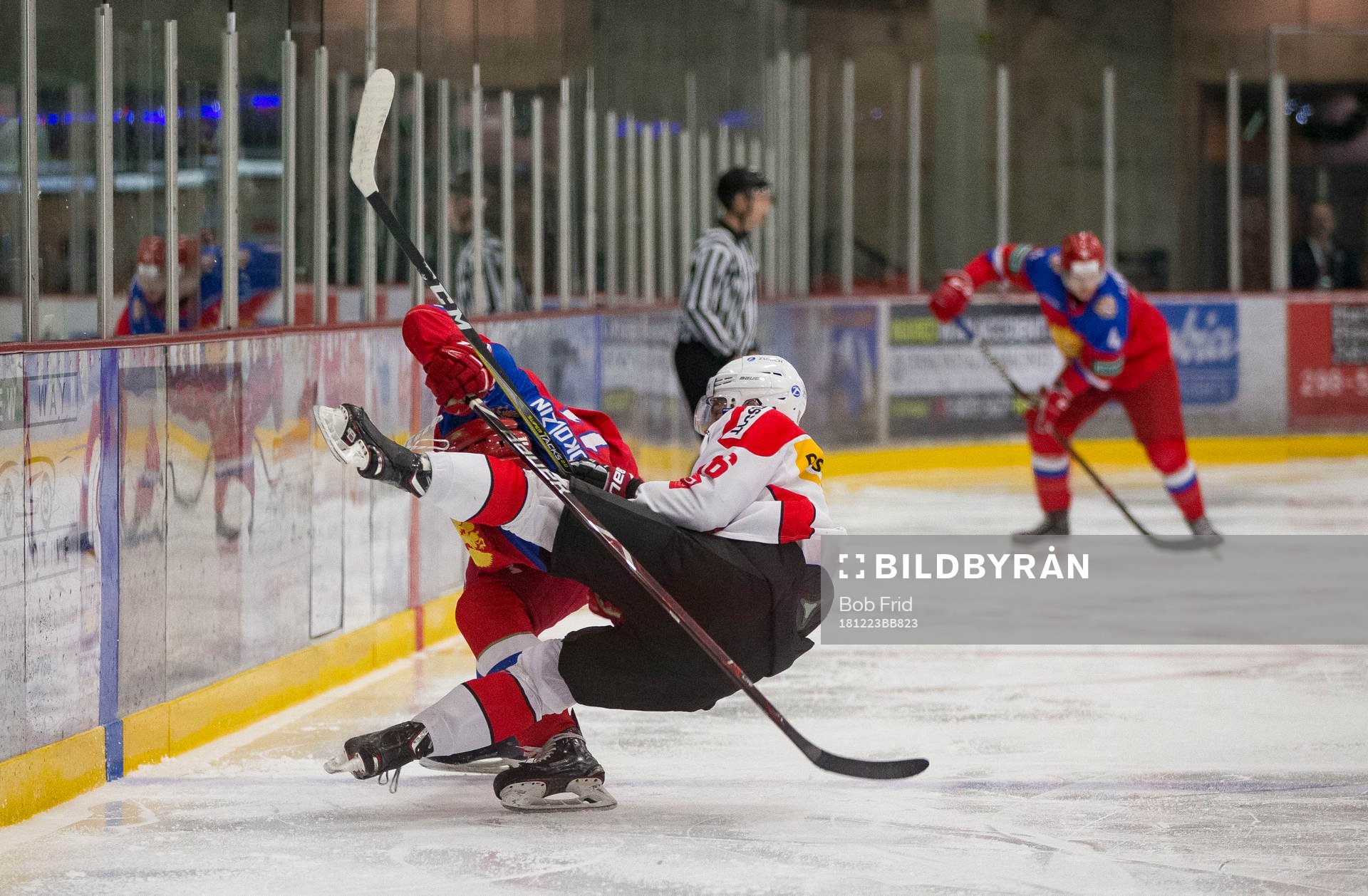 Switzerland defenceman Nico Gross (16)  checks Russia