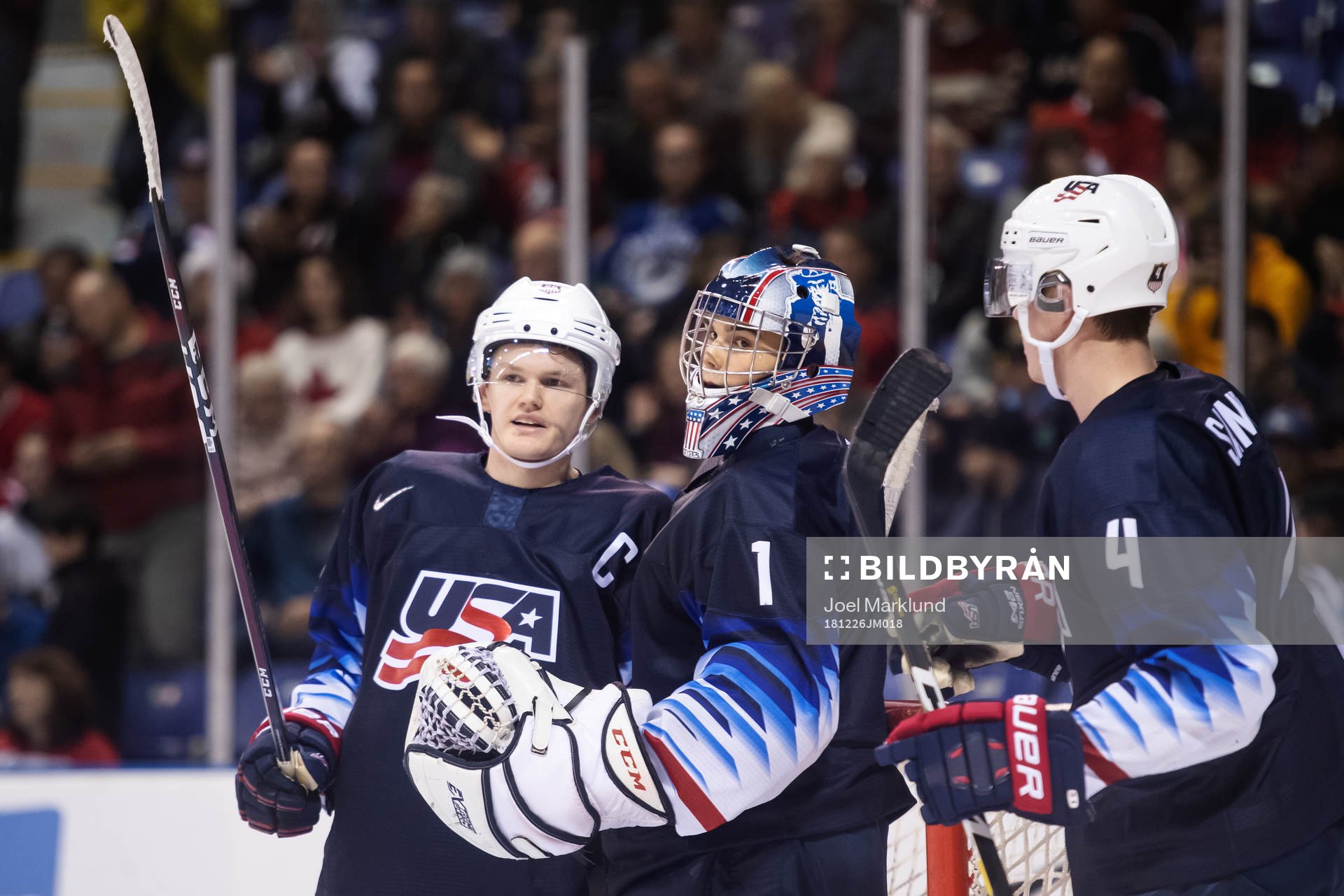 Mikey Anderson, goaltender Kyle Keyser and Dylan Samberg of