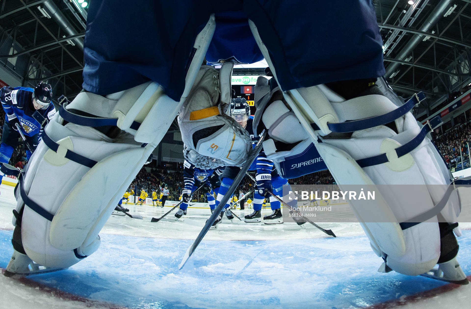 Aarne Talvitie of Finland is seen between the shin pads of