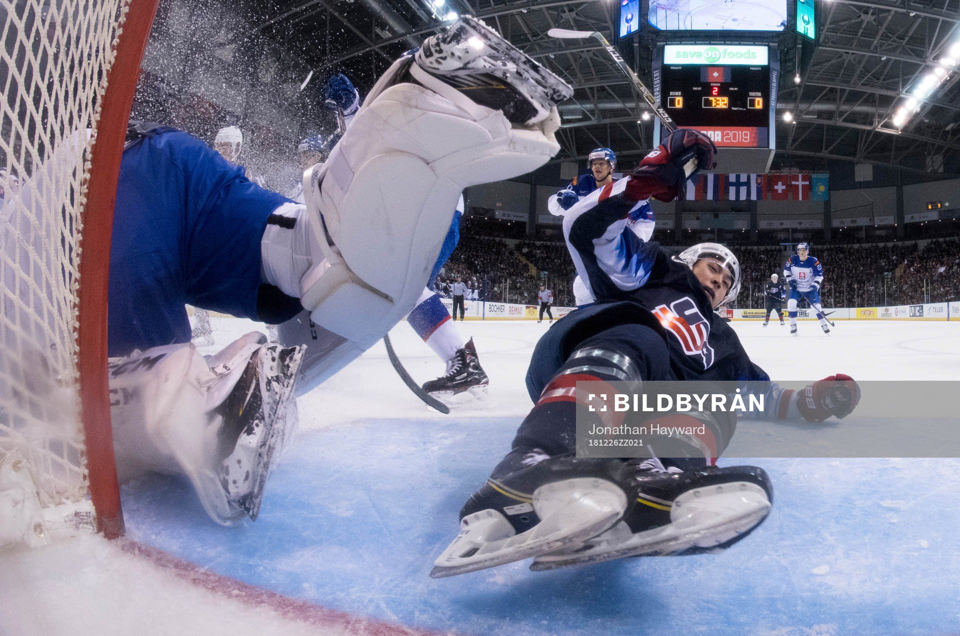 Team U.S.A.'s Jason Robertson crashes into Slovakia's