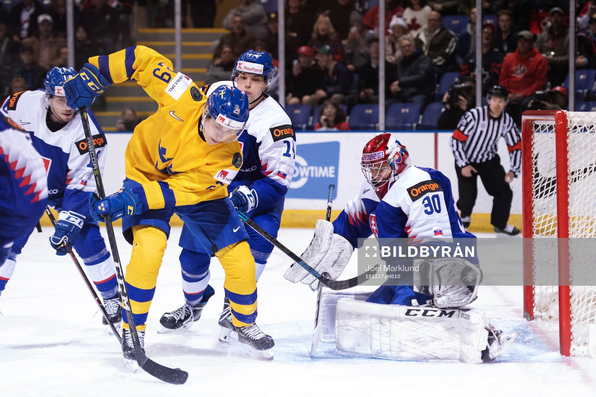 Pontus Holmberg of Sweden in front of goaltender Juraj