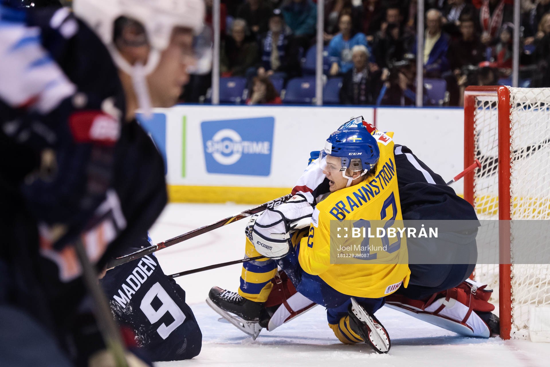 Erik Brännström of Sweden wrestle goaltender Kyle Keyser