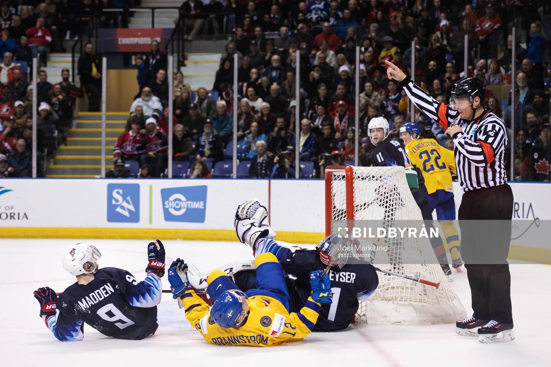Tyler Madden and goaltender Kyle Keyser of USA and Erik