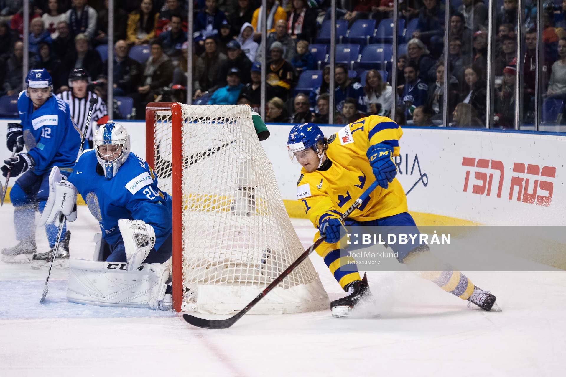 Goaltender Denis Karatayev of Kazakhstan and Samuel Fagemo