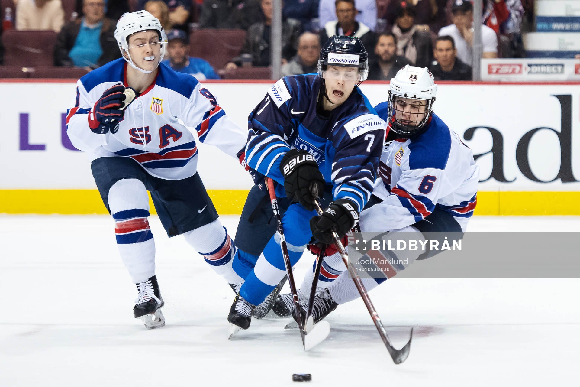 Tyler Madden and Jack Hughes of USA in action against Urho
