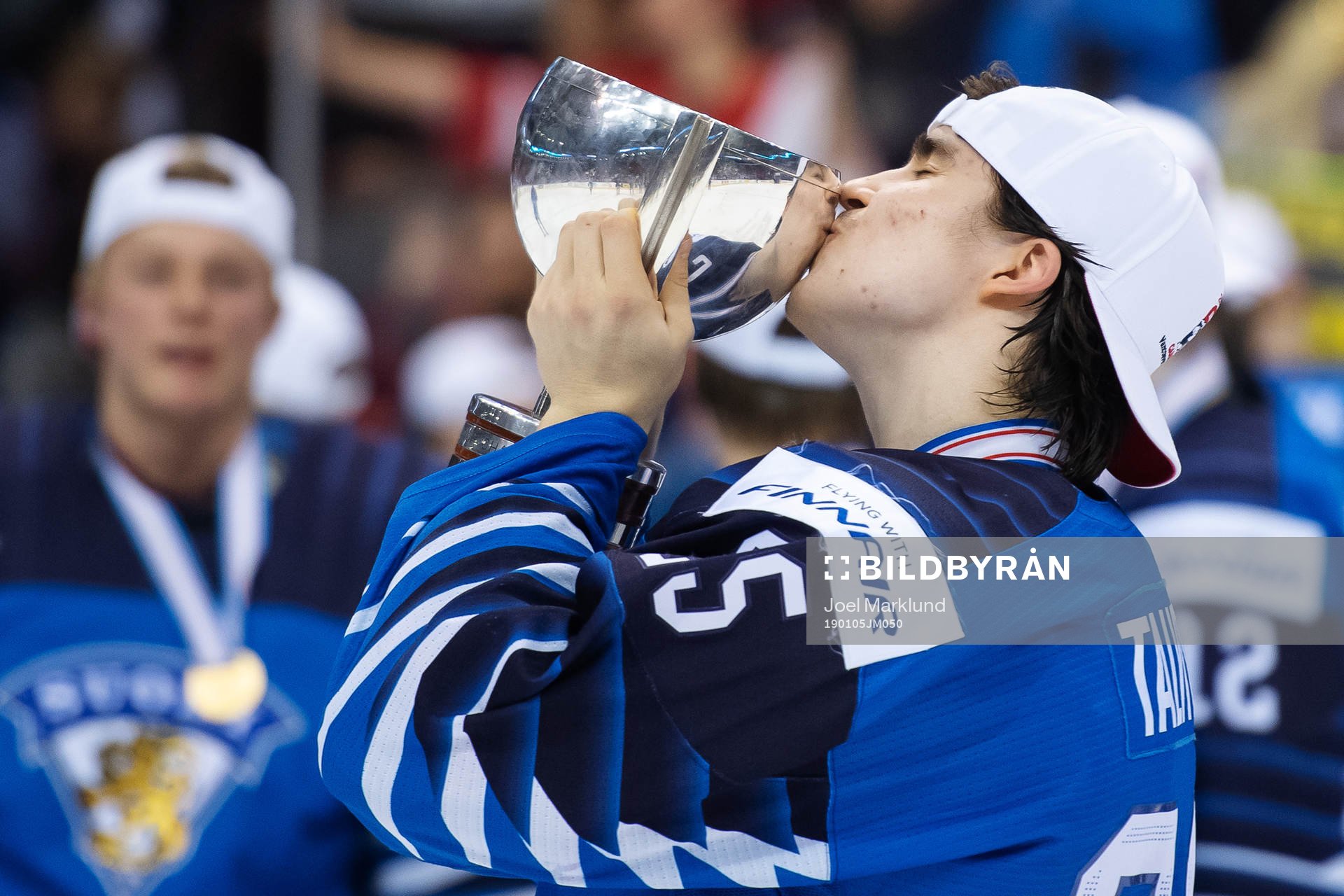 Aarne Talvitie of Finland kisses the winner's trophy