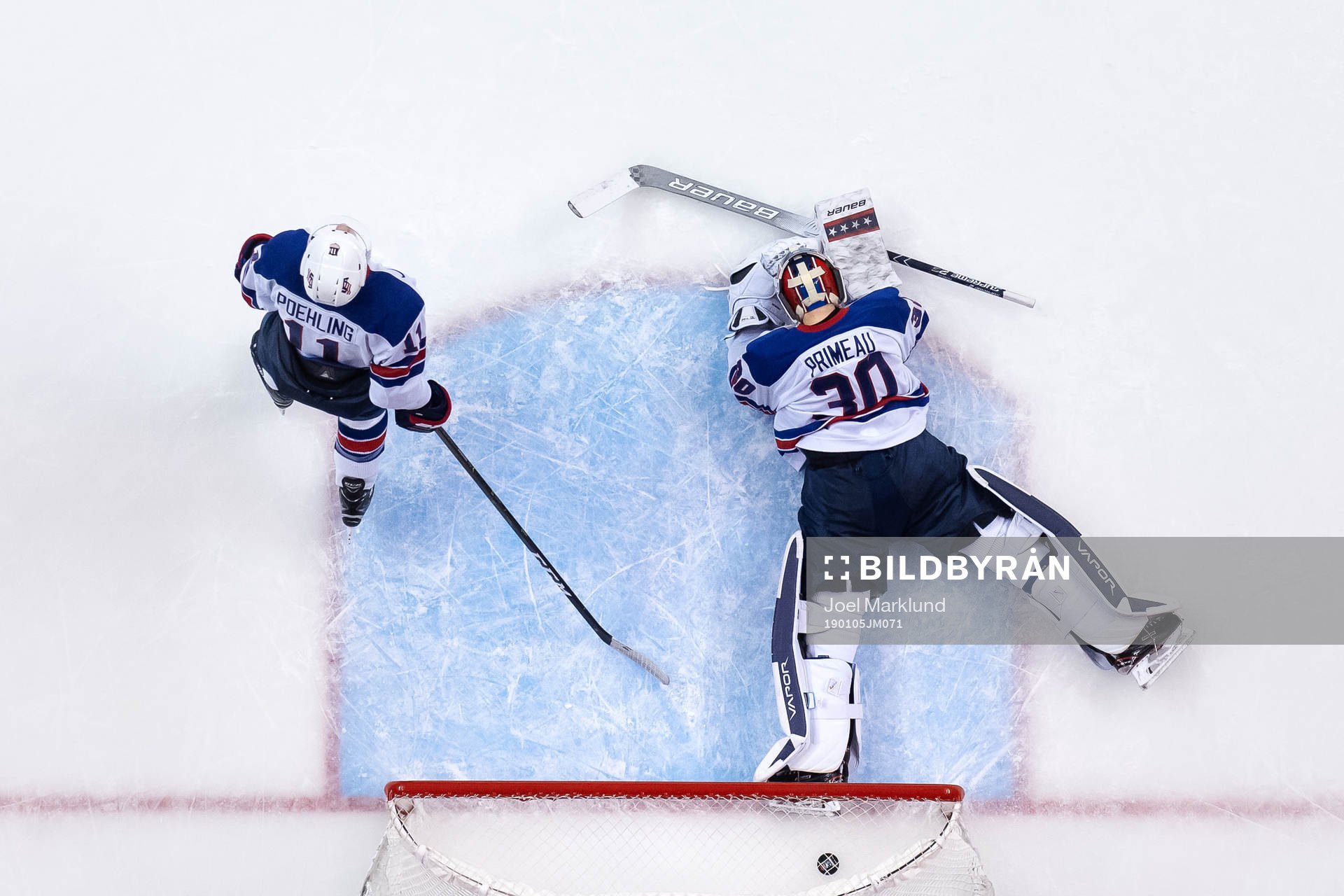 Ryan Poehling and goaltender Cayden Primeau of USA look