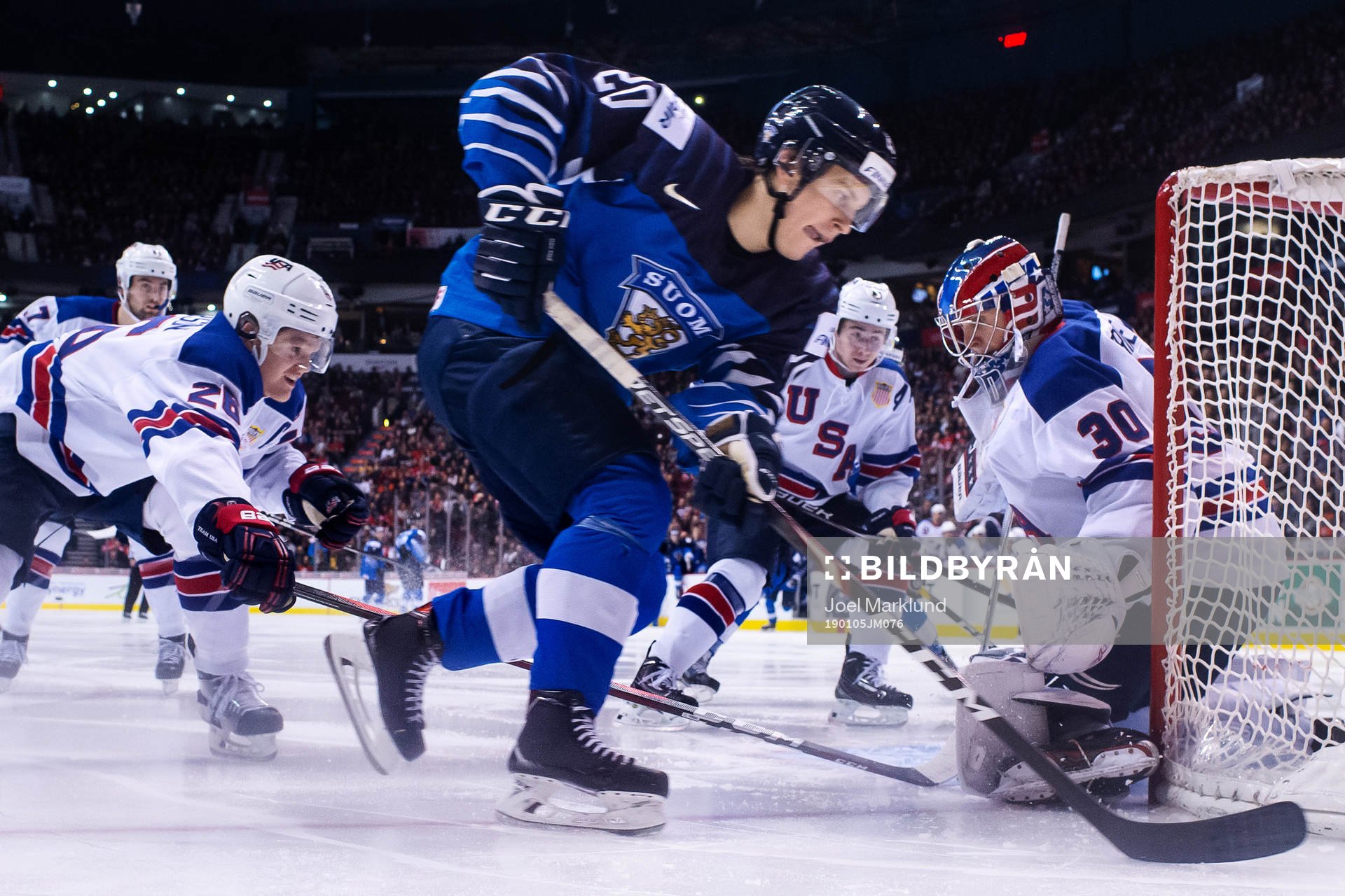 Mikey Anderson and goaltender Cayden Primeau of USA are
