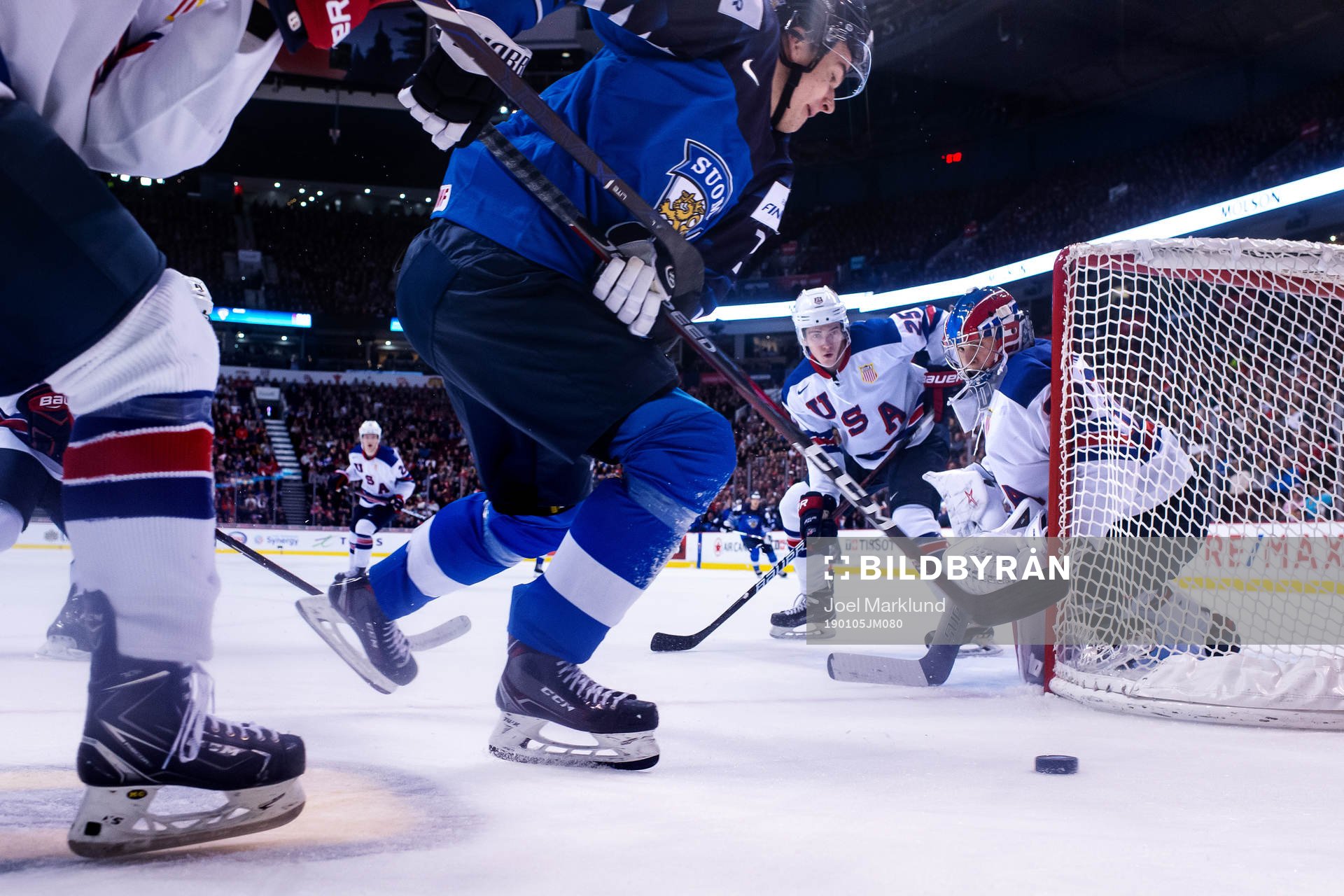Phil Kemp and goaltender Cayden Primeau of USA see Oskari