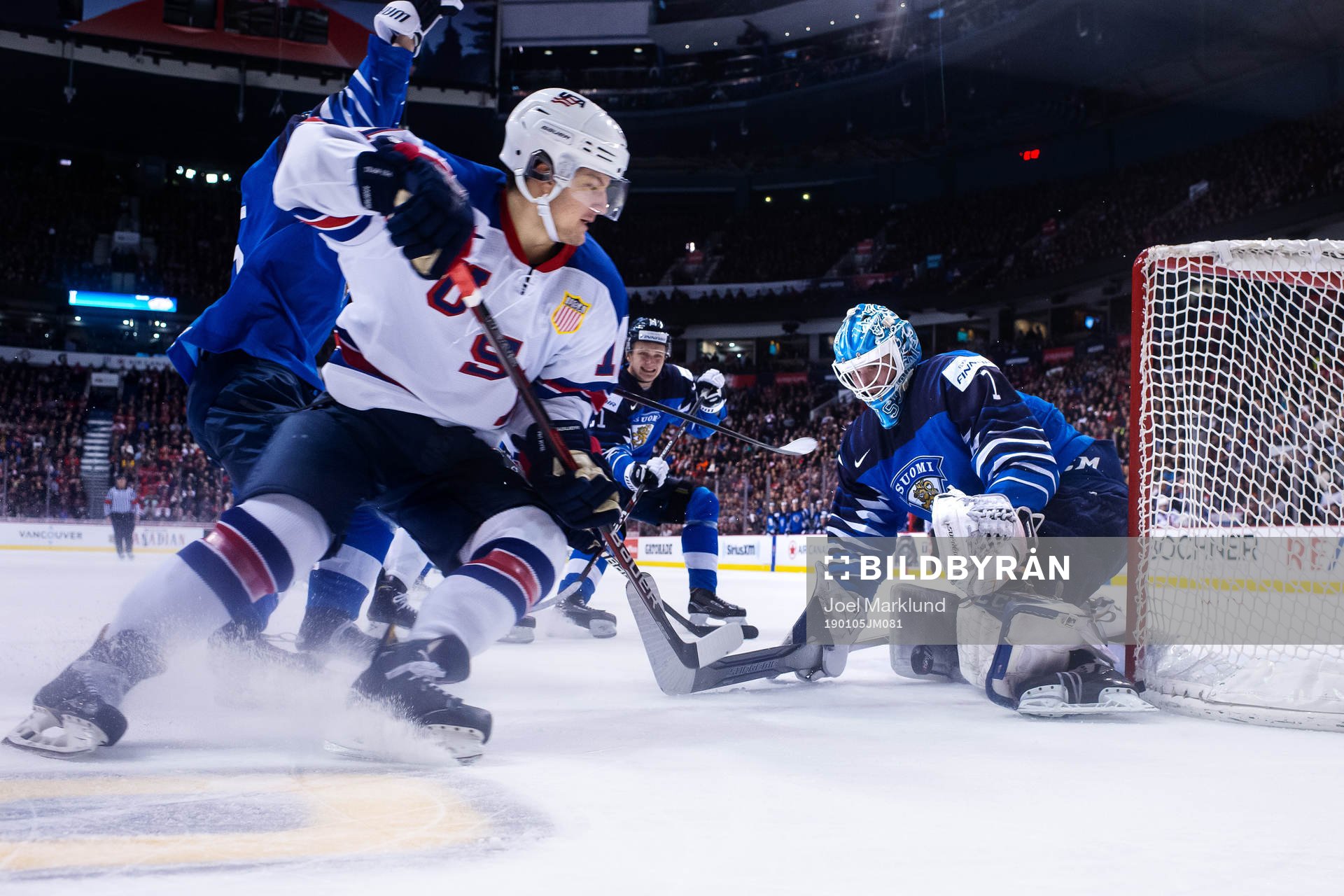 Logan Cockerill of USA in front of goaltender Ukko-Pekka